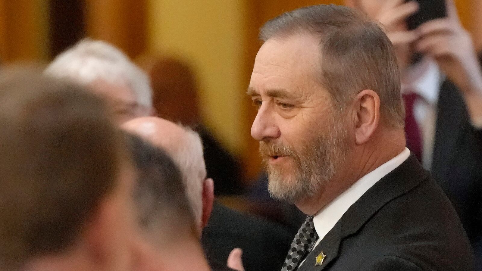 Ohio Attorney General Dave Yost mingles in the Ohio House chambers before Ohio Governor Mike DeWine gives his 2024 State of the State address at the Ohio Statehouse on Wednesday, April 10, 2024 in Columbus, Ohio. (Barbara J. Perenic /The Columbus Dispatch via AP)