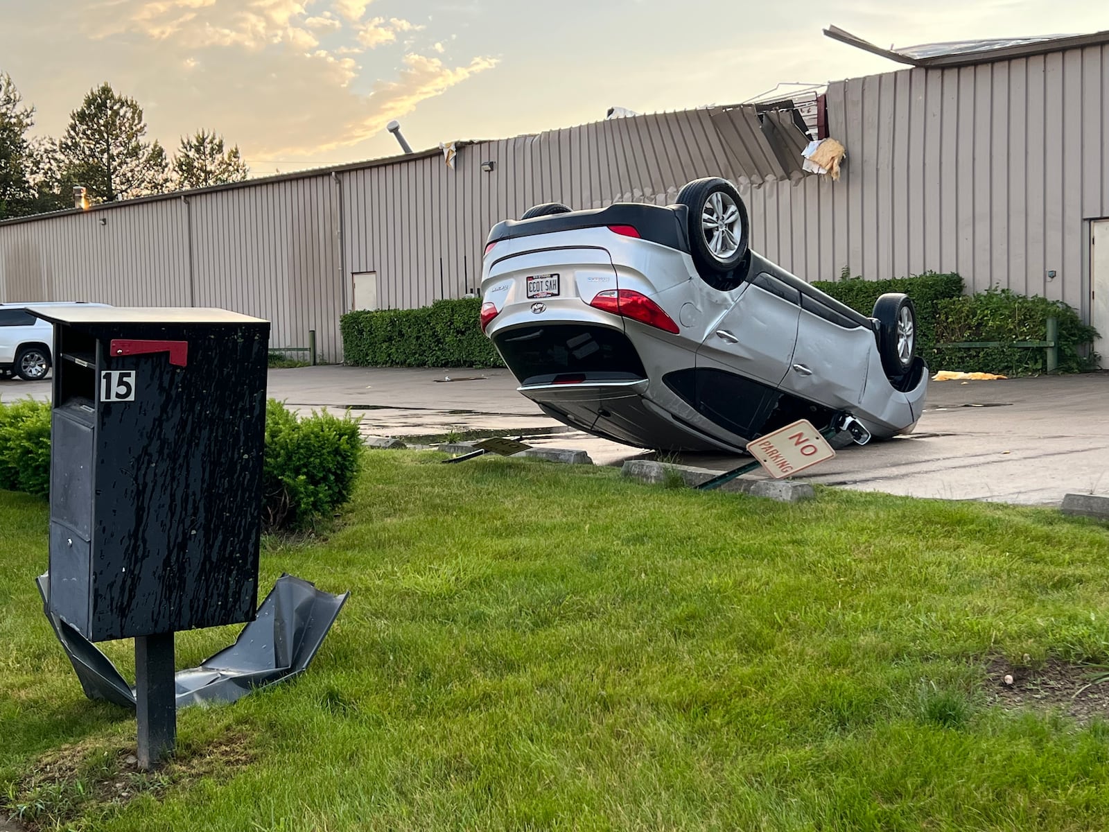 A car was flipped upside down and moved one parking spot over during Wednesday's tornado that tore through the area of Industrial Park Court in Tipp City. AIMEE HANCOCK/STAFF