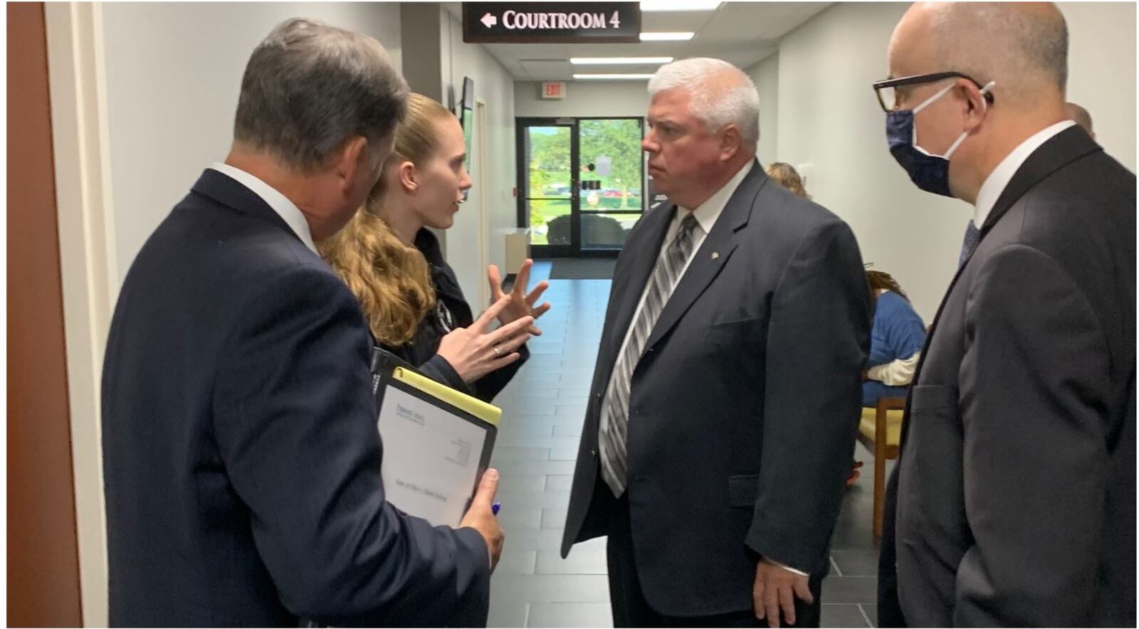 Former Springboro Schools Superintendent Daniel Schroer, center right, meets with a Warren County Common Pleas Court pre-trial services staff member following his arraignment on felony charges Friday, Aug. 20, 2021. Schroer entered not guilty pleas and will remain free on his own recognizance. ED RICHTER/STAFF