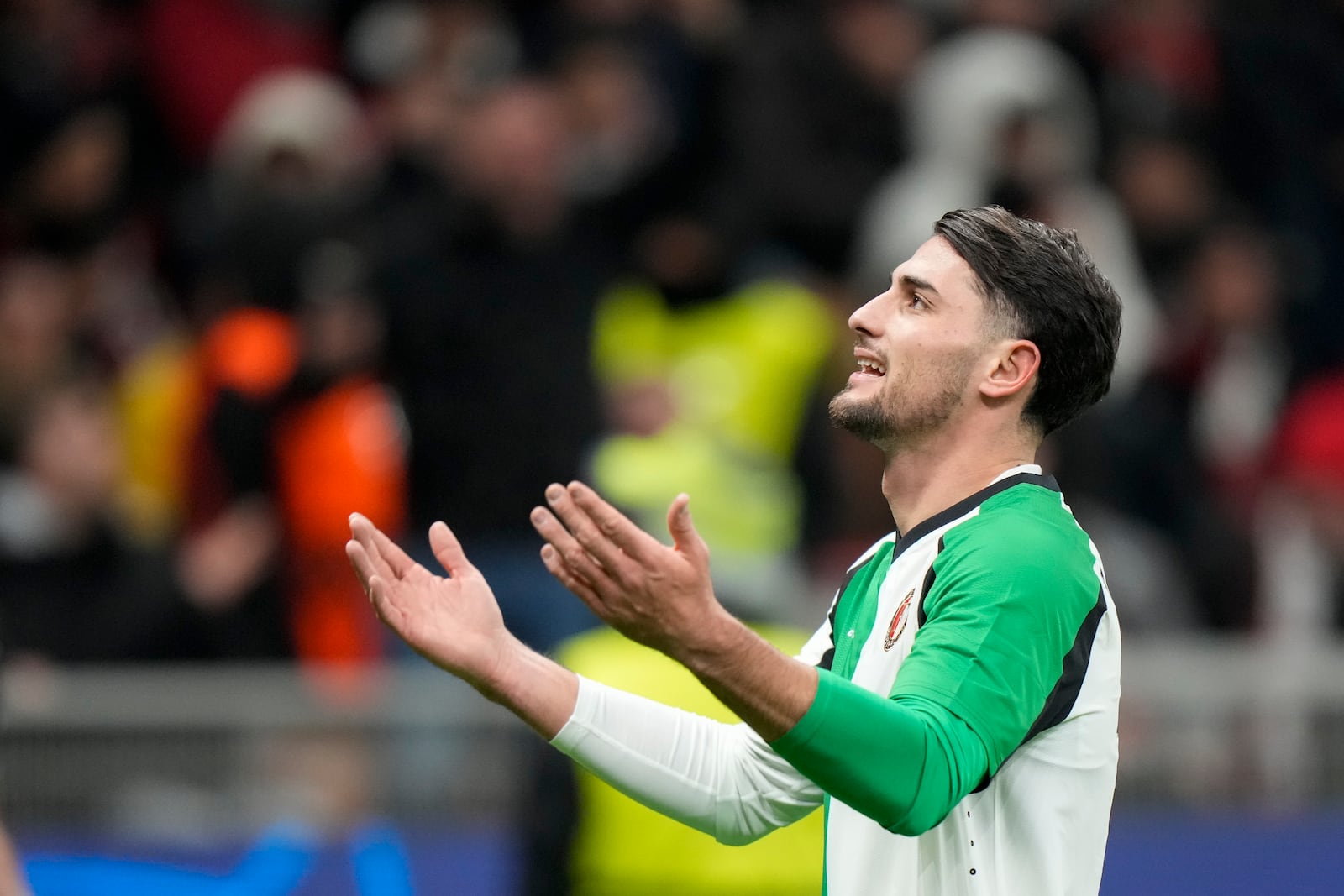 Feyenoord's Julian Carranza celebrates after scoring his side's first goal during Champions League, playoff second leg soccer match between AC Milan and Feyenoord, at the San Siro stadium in Milan, Italy, Tuesday, Feb.18, 2025. (AP Photo/Luca Bruno)