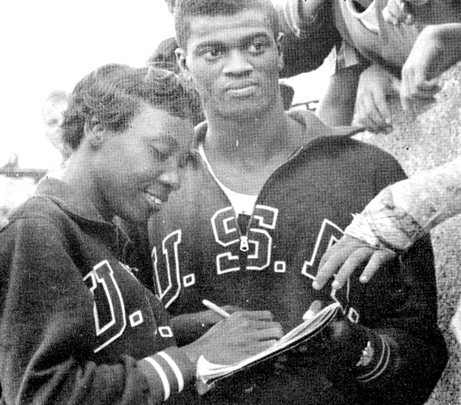 Lucinda Williams signs an autograph during the 1960 Rome Olympics. At right is fellow Olympian Ray Norton.  Photo courtesy of Tennessee State University.