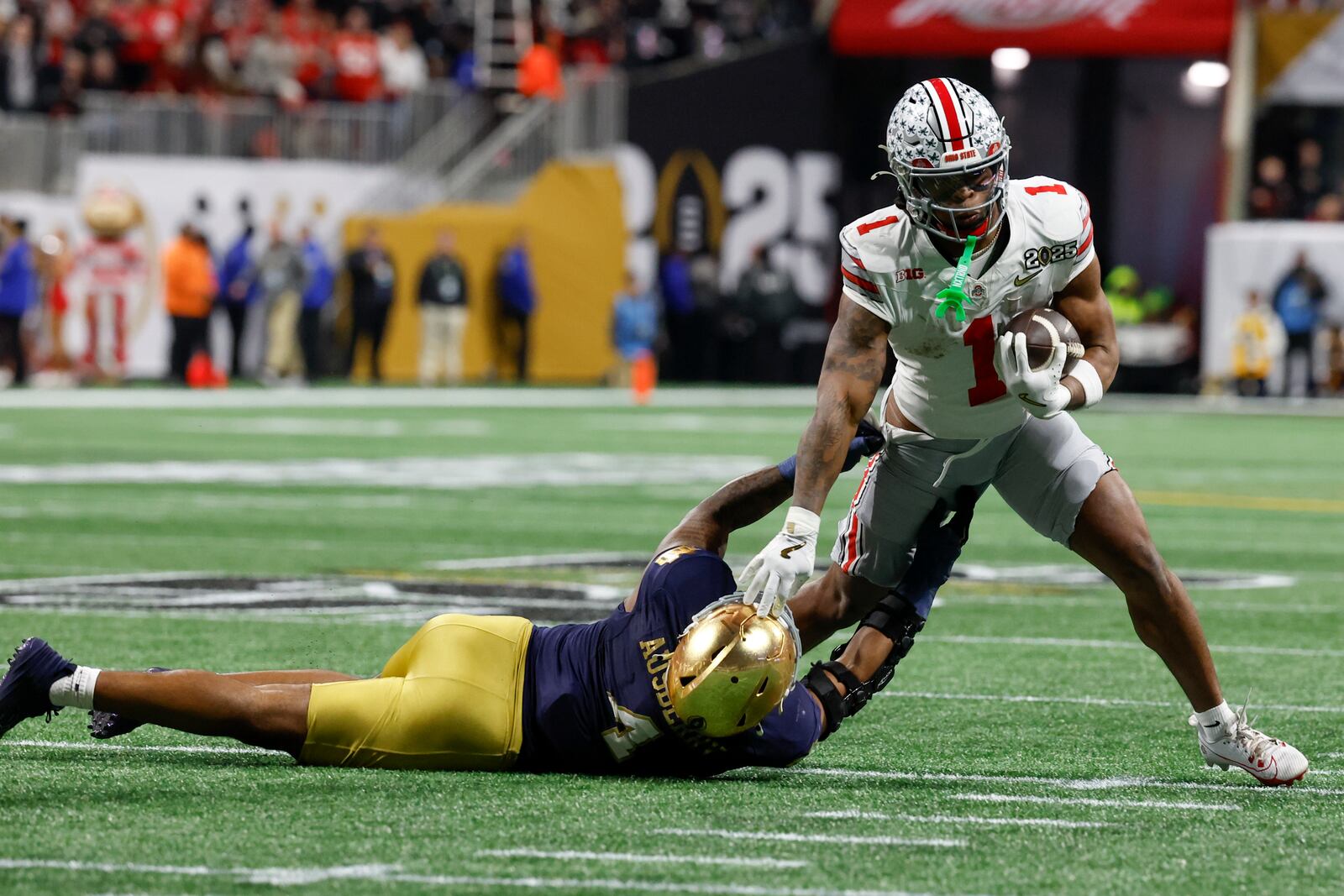 Ohio State running back Quinshon Judkins runs for a touchdown past Notre Dame linebacker Jaiden Ausberry during first half of the College Football Playoff national championship game Monday, Jan. 20, 2025, in Atlanta. (AP Photo/Butch Dill)