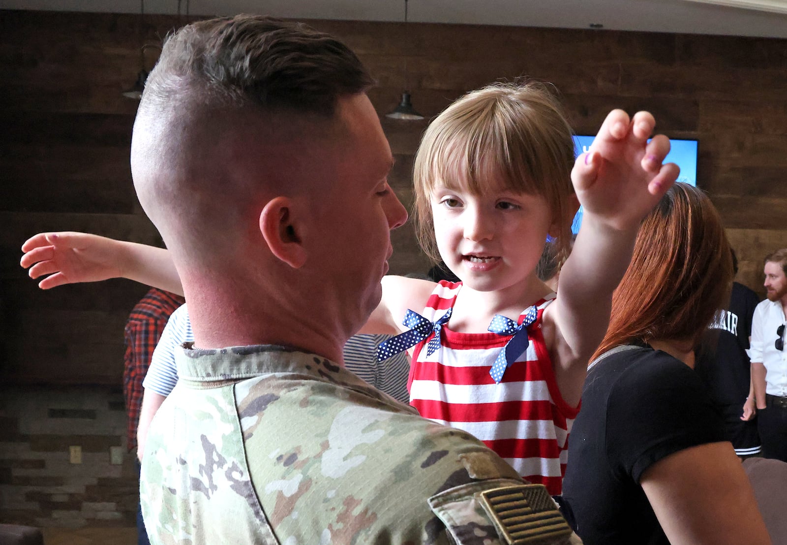 Calliope East gives her father, SSG Jacob East of the Ohio Army National Guard 1137th Tactical Installation Networking Enhanced Signal Company, a hug following a Call to Duty Ceremony for the unit Saturday, August 31, 2024 at the First Christian Church in Springfield. BILL LACKEY/STAFF