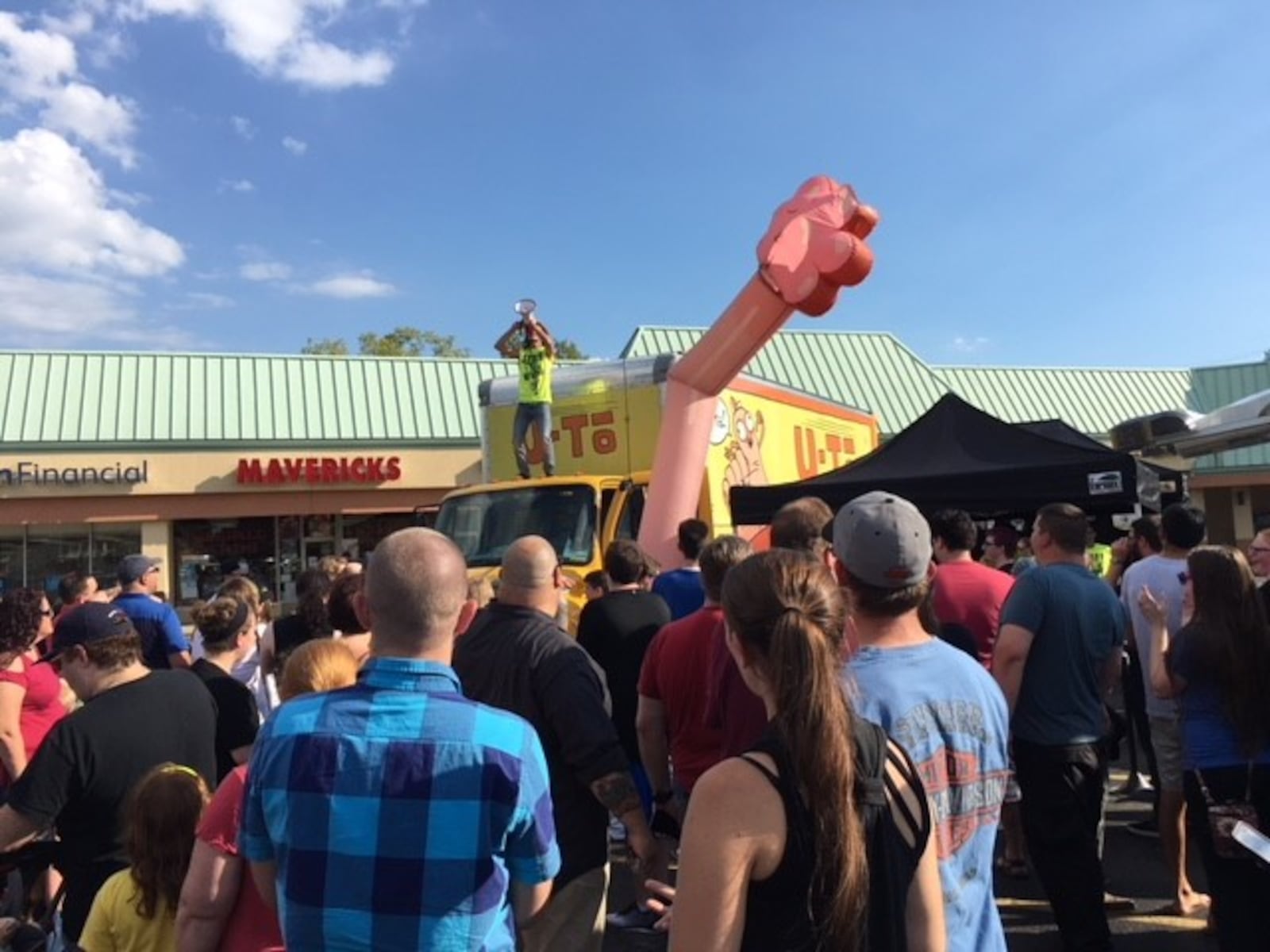 Adult Swim's Rick and Morty is touring coast to coast with the "Rickmobile" — a mobile shop with exclusive merchandise. The Rickmobile made one of only two Ohio stops at Maverick's Cards and Comics in Kettering on Sept. 18. The "Don't Even Trip Road Trip" stop came to promote the popular Adult Swim series "Rick and Morty" which just won an Emmy. Hundreds of fans showed up to get in front of a shopping tent with exclusive “Rick and Morty” items for sale in the parking lot in front of the comic store.  ALEXIS LARSEN/CONTRIBUTED