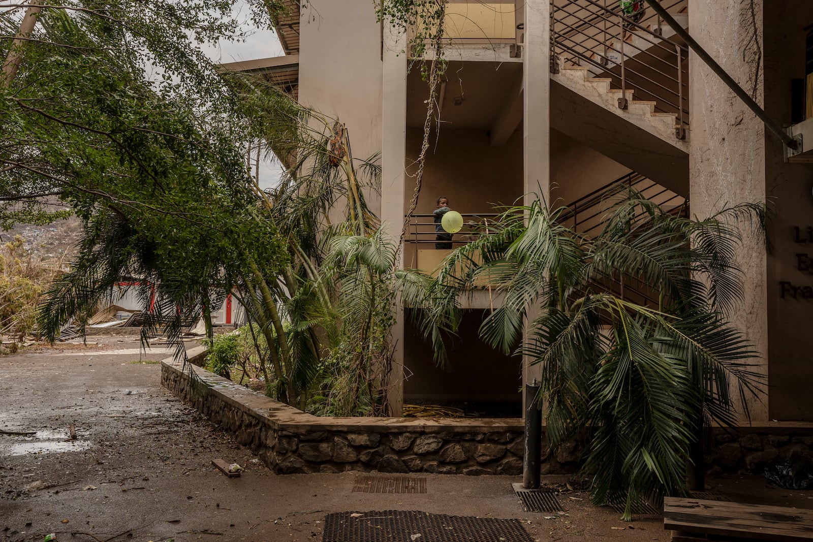 A child plays at the Lycée des Lumières where he found shelter, in Mamoudzou, Mayotte, on Thursday, Dec. 19, 2024. (AP Photo/Adrienne Surprenant)