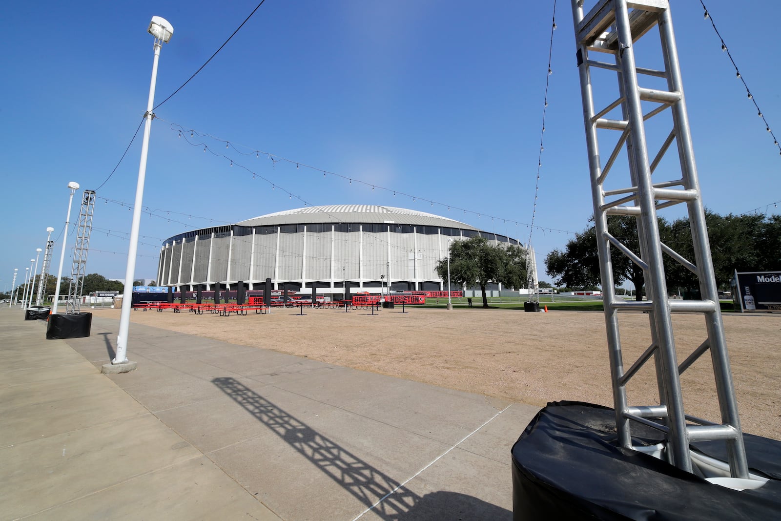 An area for tailgating during Houston Texans NFL games now played at the adjacent NRG Stadium, on the south side of the now dormant Astrodome Wednesday, Nov. 13, 2024, in Houston. The Astrodome Conservancy, a group dedicated to preserving the structure, has proposed a multi-use renovation for the once legendary building. (AP Photo/Michael Wyke)