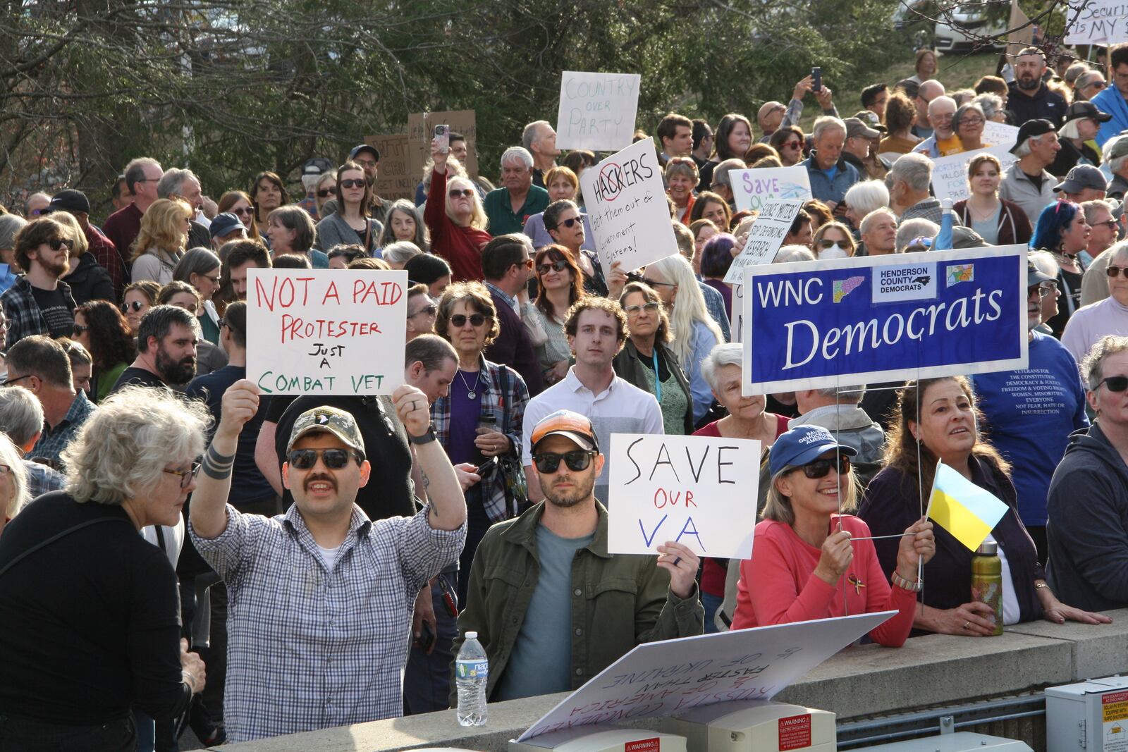 Protesters show up with signs to a town hall held by Rep. Chuck Edwards in Asheville, N.C. on Thursday, March 13, 2025. (AP Photo/Makiya Seminera)