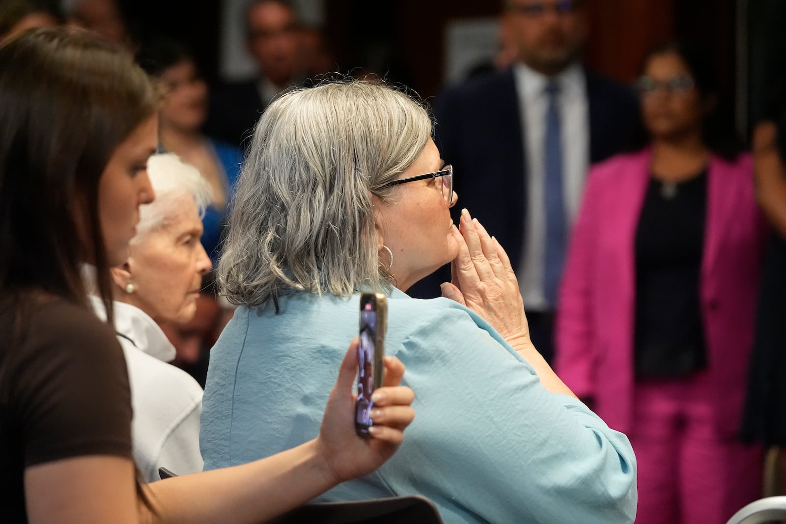 Diane Hernandez, Niece of Kitty Menendez, holds her hands as Los Angeles County District Attorney George Gascon announces he will ask a judge to resentence Erik and Lyle Menendez, two brothers serving life sentences for killing their parents, at a news conference at the Hall of Justice in Los Angeles on Thursday, Oct. 24, 2024, in Los Angeles. (AP Photo/Damian Dovarganes)