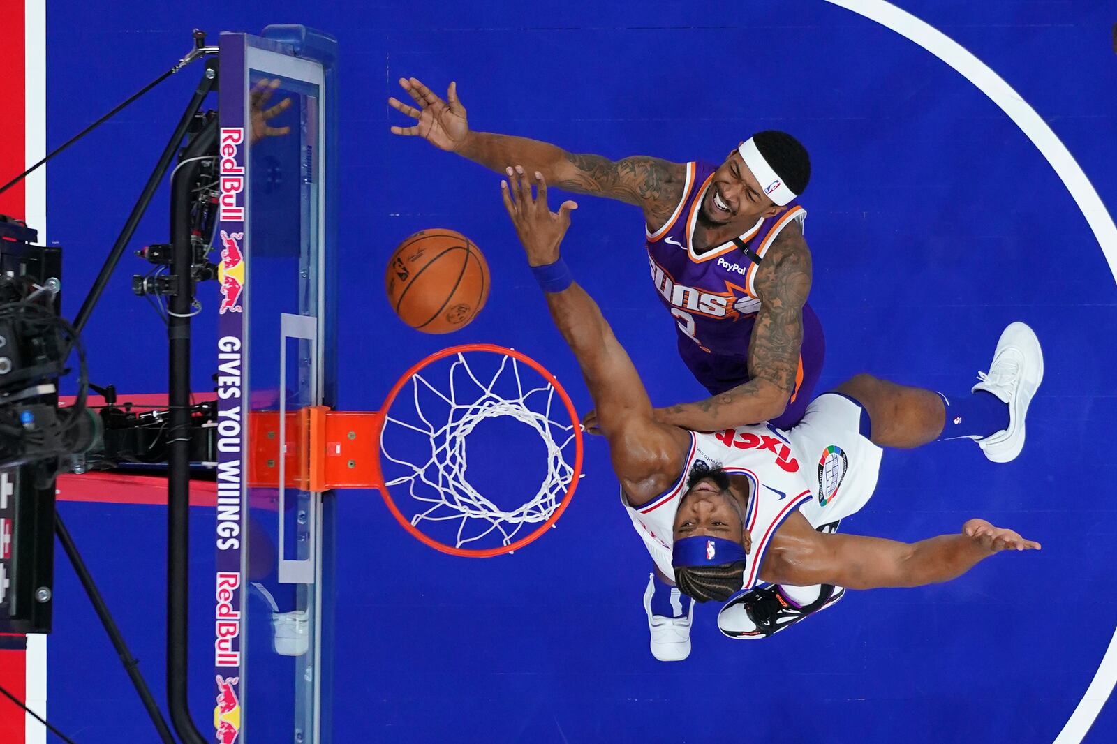 Phoenix Suns' Bradley Beal, top, goes up for a shot against Philadelphia 76ers' Guerschon Yabusele during the first half of an NBA basketball game, Monday, Jan. 6, 2025, in Philadelphia. (AP Photo/Matt Slocum)