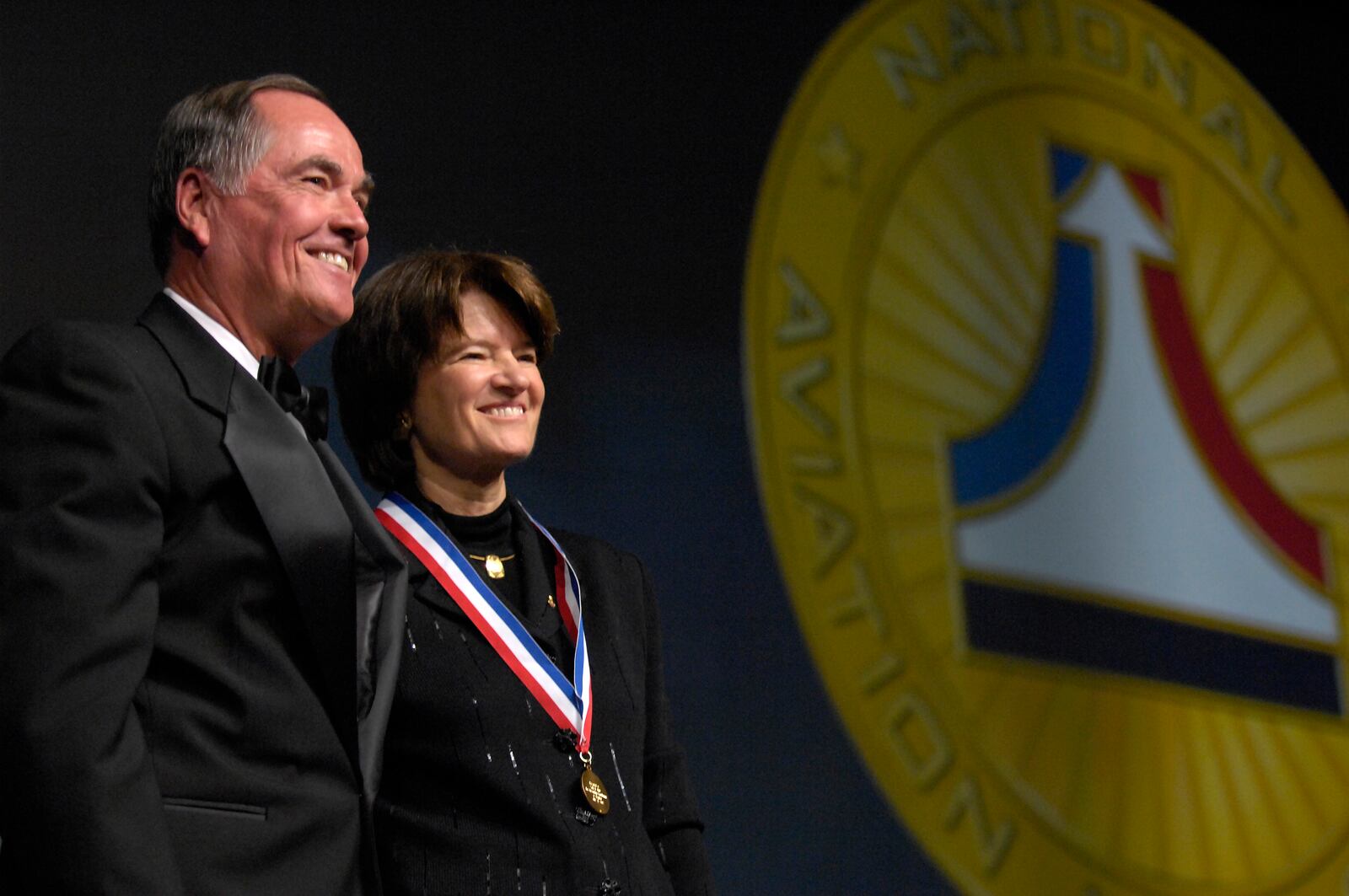 Sally Ride, the first American woman in space, is presented a medal symbolizing her induction into the National Aviation Hall of Fame by friend and former astronaut Robert Crippen on Saturday.  Ride was one of five aviators honored at the event.  Staff photo by Dave Munch