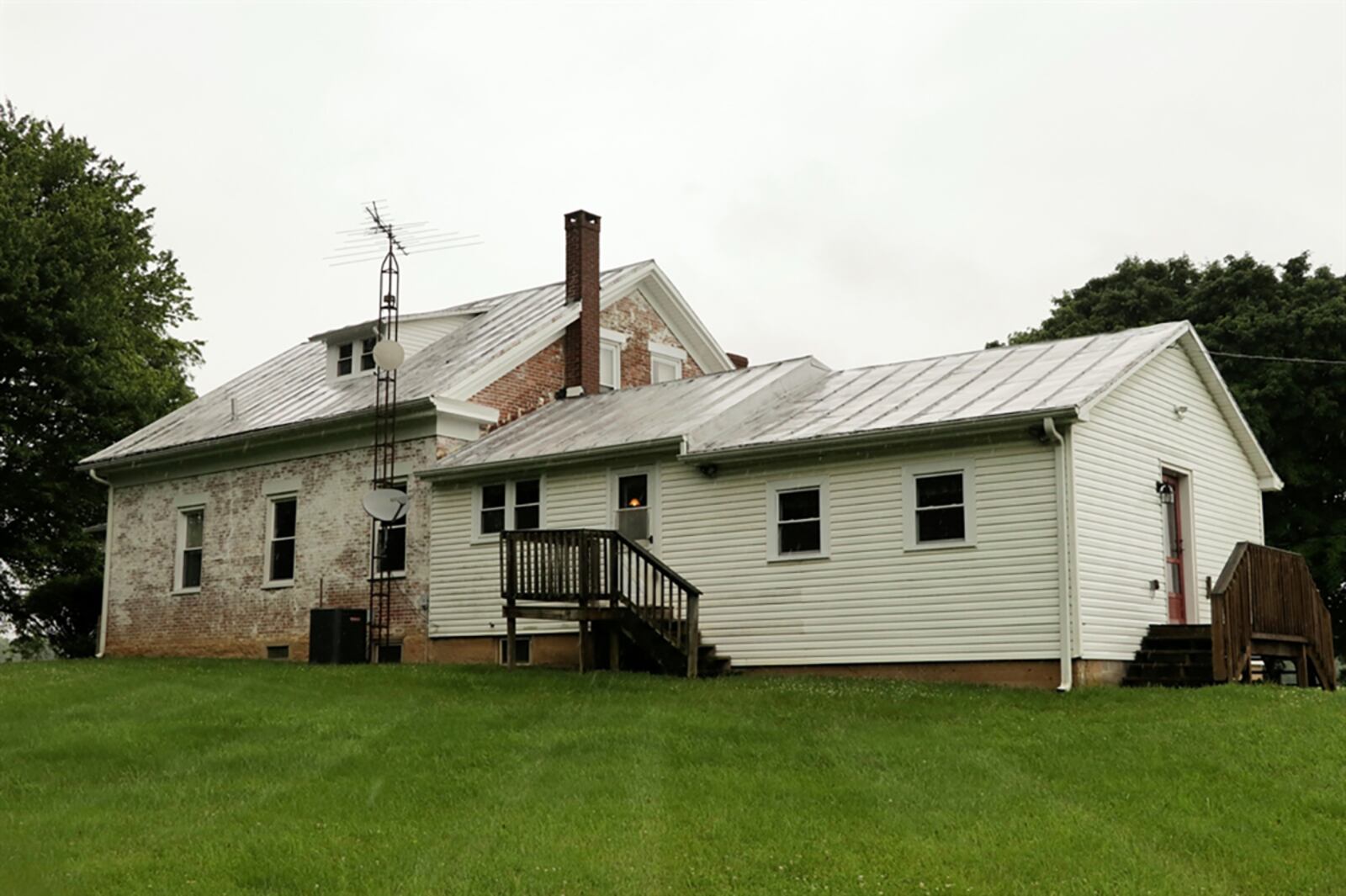 The main house has all the brick and wood construction of the original farmhouse while a garage has been attached for additional living space. Across the back of the house is the kitchen with a dining area and side-porch entrance. CONTRIBUTED PHOTO BY KATHY TYLER