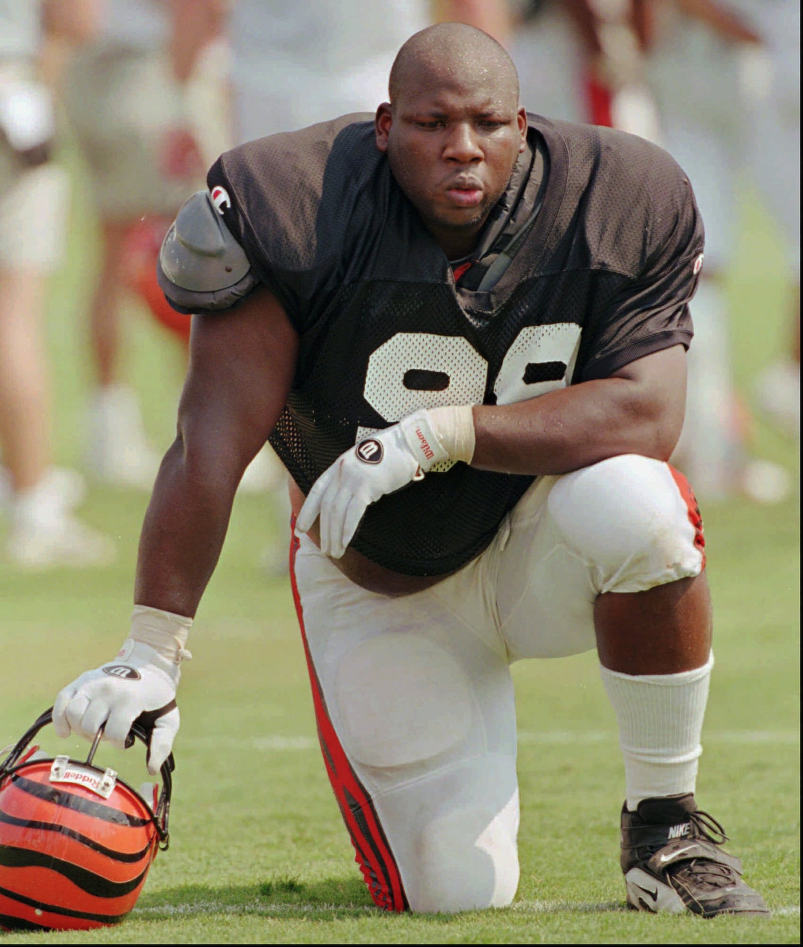 FILE -- Cincinnati Bengals defensive end Dan Wilkinson takes a break during practice Friday, July 18, 1997, at the NFL team's training camp in Georgetown, Ky. (AP Photo/Al Behrman)