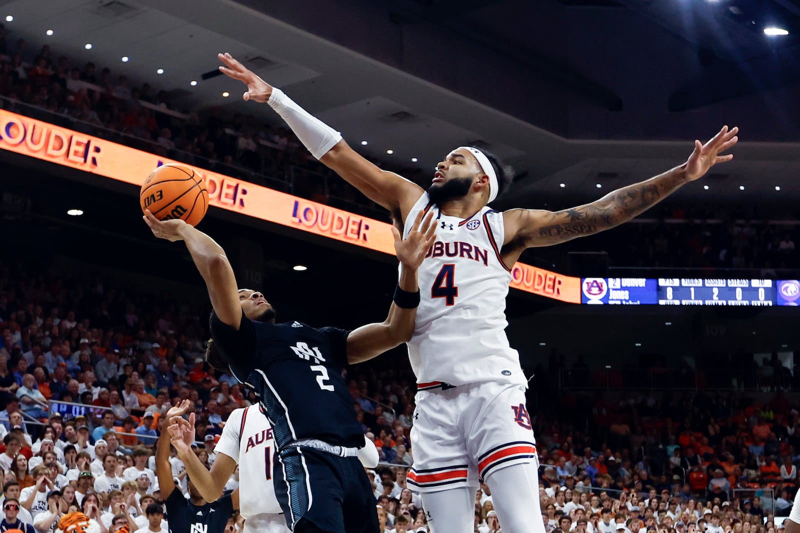 North Alabama guard Daniel Ortiz (2) shoots as Auburn forward Johni Broome (4) tries to block the shot during the first half of an NCAA college basketball game, Monday, Nov. 18, 2024, in Auburn, Ala. (AP Photo/Butch Dill)