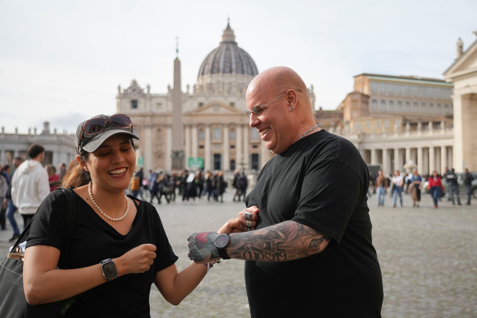 Jose Enrique Escardo, a victim of Peru's Sodalitium Christianae Vitae movement, right, shares a smile with his friend Brisa De Angulo, executive director of the association, A Breeze of Hope before an interview with the Associated Press in front of St. Peter's Basilica, in Rome, Saturday, Jan. 25, 2025. (AP Photo/Alessandra Tarantino)