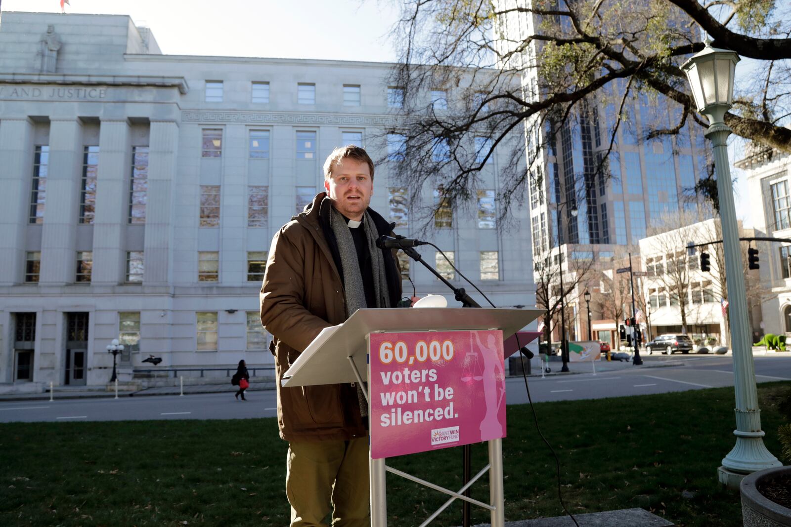 Ian McPherson reads names from a list of over 60,000 people who cast ballots in the November 2024 election but whose votes have been challenged by Republican state Supreme Court candidate Jefferson Griffin in his extremely close race with Demcoratic Associate Justice Allison Riggs, Tuesday, Jan. 14, 2025, in Raleigh, N.C. Behind him is the North Carolina Supreme Court. (AP Photo/Chris Seward)