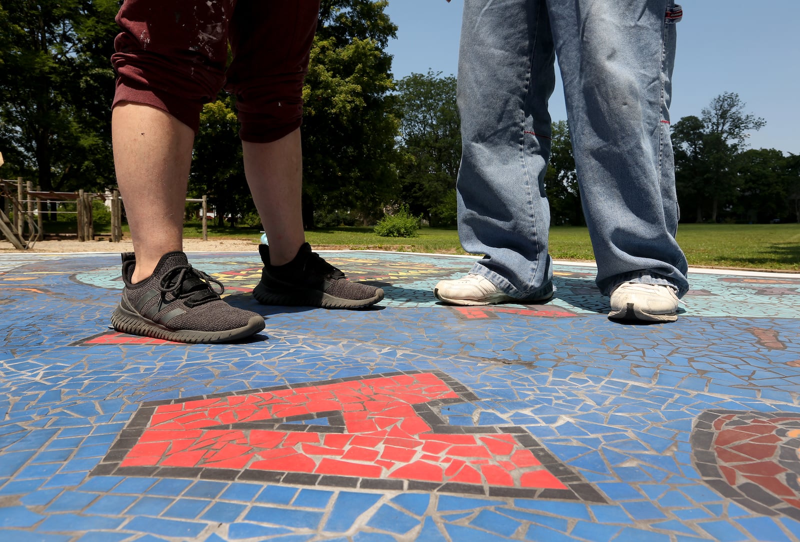 "Together We Rise," is a new  large-scale play area and work of art in West Dayton. The in-ground mosaic is a play station designed with interactive games, alphabet letters and raised areas for crayon rubbings. It is located in a playground at the intersection of Harvard Boulevard and Burroughs Drive on the Omega CDC Harvard Campus.  LISA POWELL / STAFF