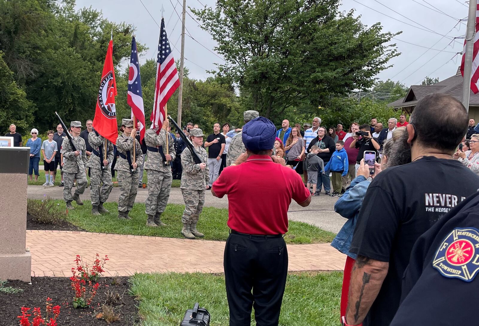 Military service members carried flags before the national anthem was played as more than 100 people who attended the 9/11 memorial event Sunday in Beavercreek. NICK BLIZZARD/STAFF