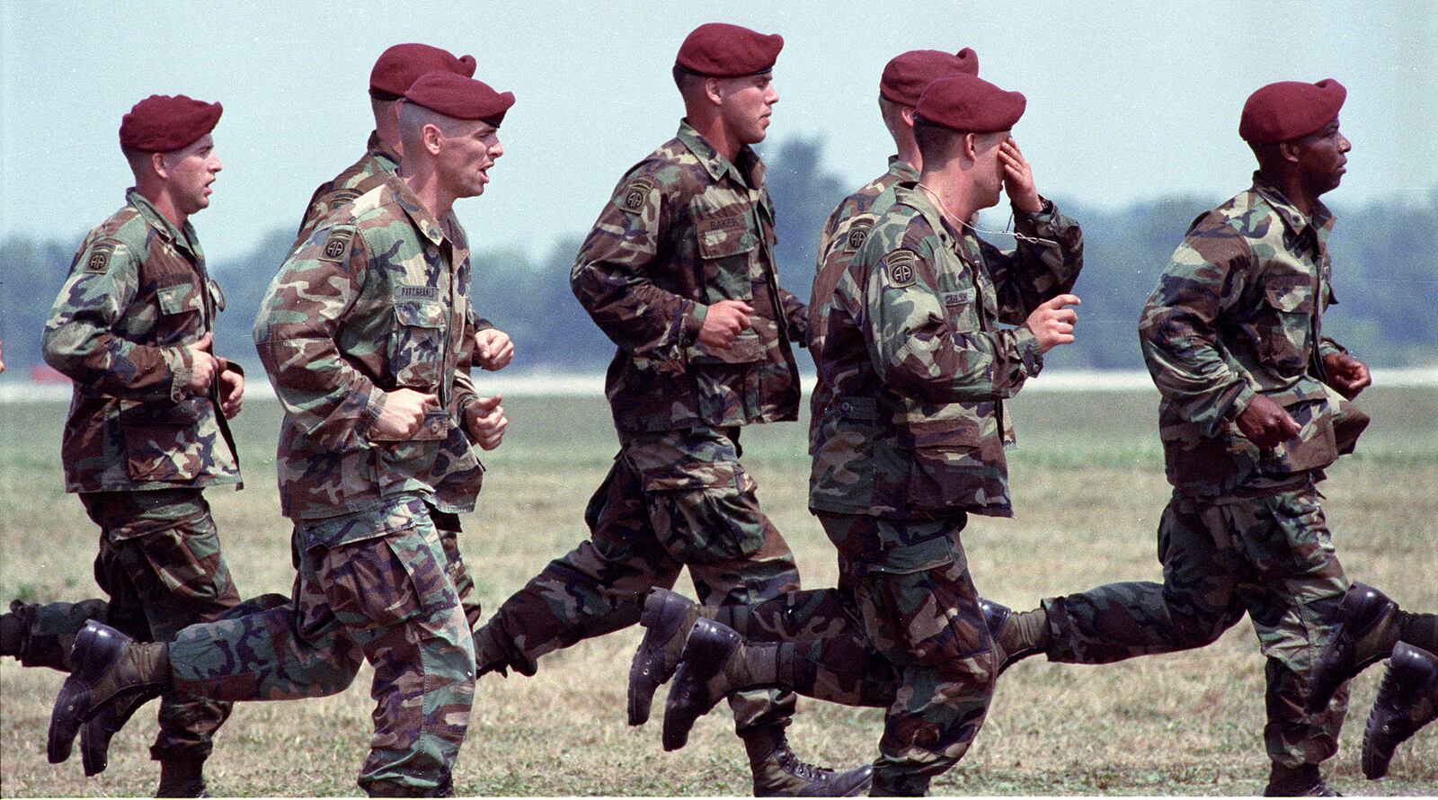 82nd Airborne troops run past the crowd line after jumping from C-141 Starlifters.