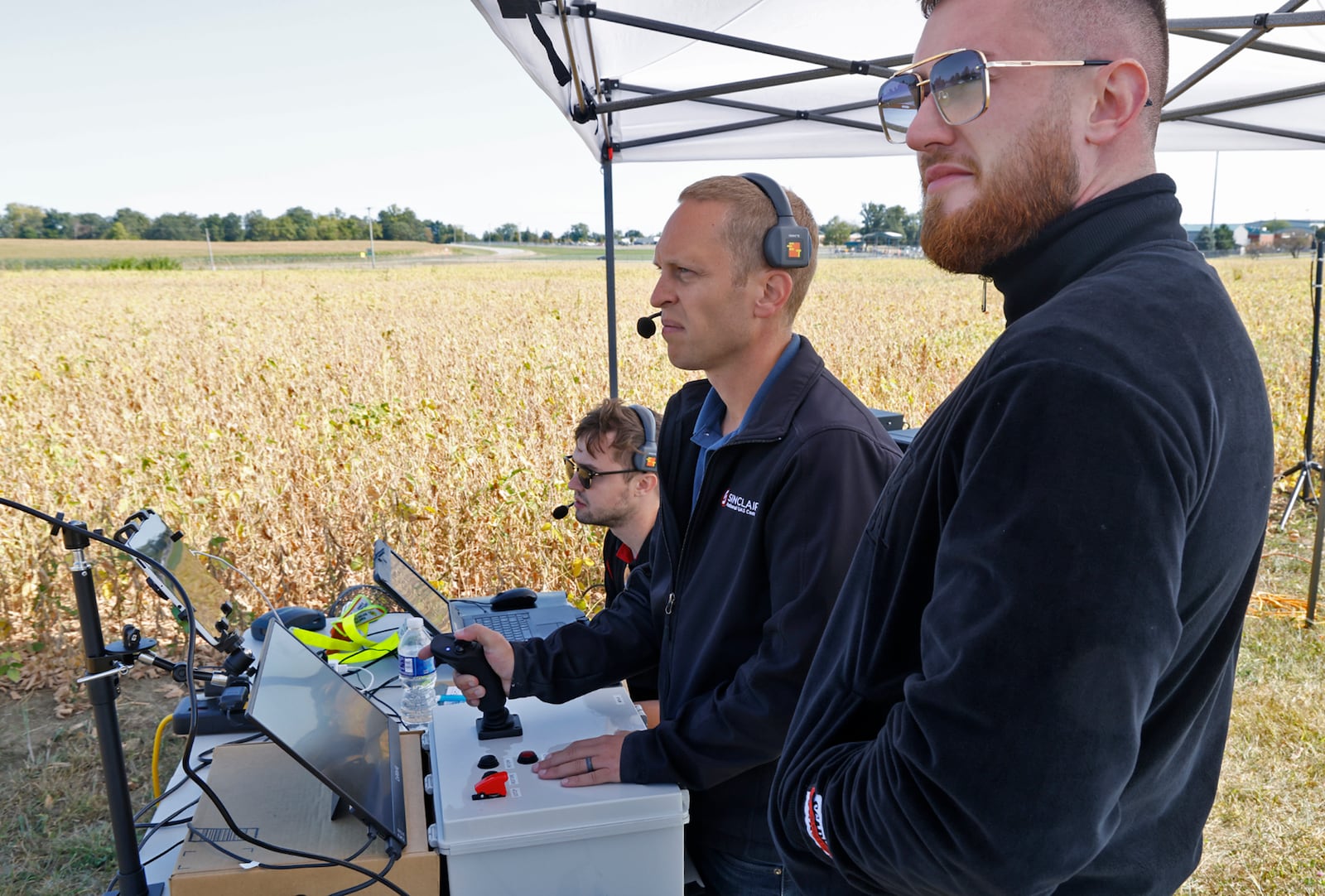 A crew from Sinclair, from right, Bruno Reichstadter, Joshua Bohun and Tristan Giardullo operates a PIVOTAL Blackfly UAV as it takes off at Springfield Beckley Airport Monday, Sept. 9, 2024. BILL LACKEY/STAFF