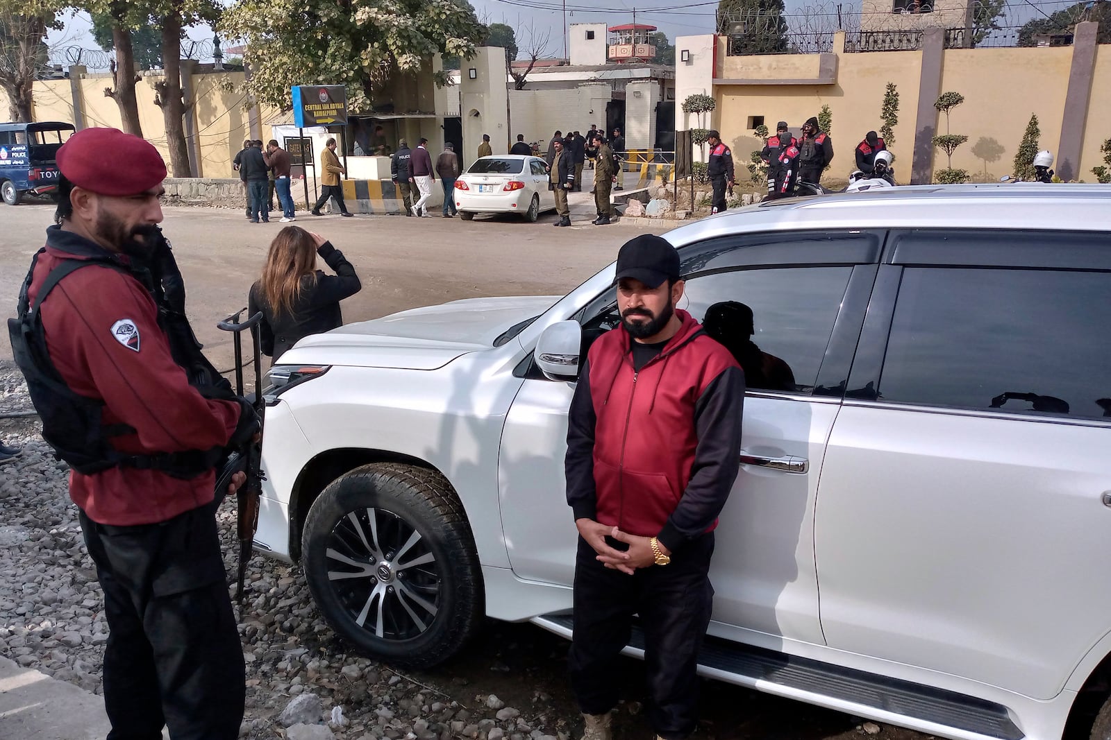 Security guards watch a vehicle carrying Bushra Bibi, wife of imprisoned former Prime Minister Imran Khan, as she arrives to hear verdict on corruption case in a court specially set up in Adiyala prison, in Rawalpindi, Pakistan, Friday, Jan. 17, 2025. (AP Photo/W.K. Yousufzai)