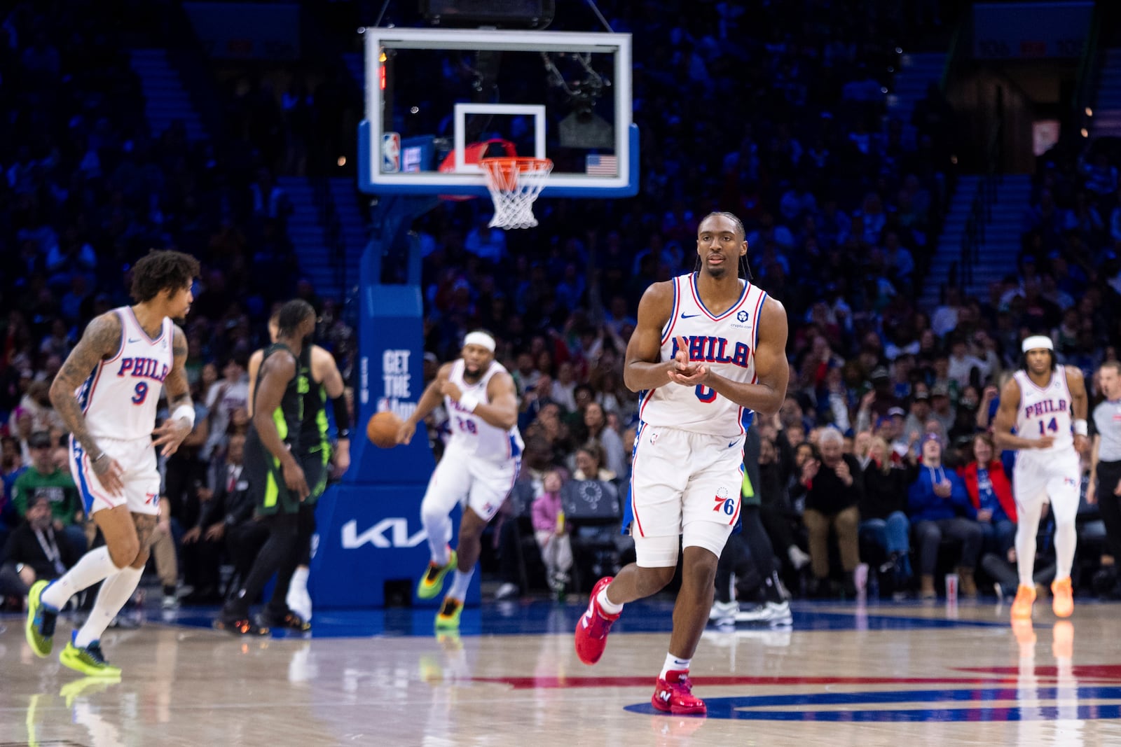 Philadelphia 76ers' Tyrese Maxey, center right, reacts after his 3-point basket during the first half of an NBA basketball game against the Boston Celtics, Sunday, Feb. 2, 2025, in Philadelphia. (AP Photo/Chris Szagola)