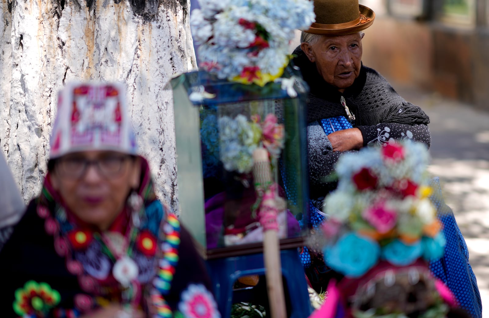 Women stand next to decorated human skulls at the General Cemetery as part of the annual "Ñatitas" festival, a tradition marking the end of the Catholic holiday of All Saints in La Paz, Bolivia, Friday, Nov. 8, 2024. (AP Photo/Juan Karita)