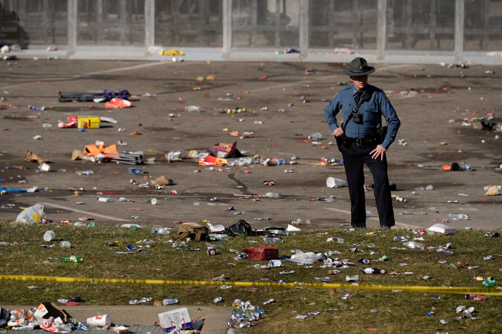 FILE - A law enforcement officer looks around the scene following a shooting at the Kansas City Chiefs NFL football Super Bowl celebration in Kansas City, Mo., Feb. 14, 2024. (AP Photo/Charlie Riedel, File)