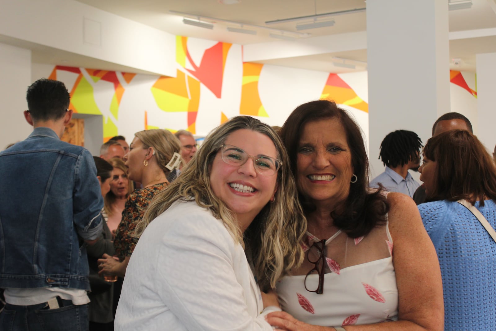 Sandy Gudorf gets a hug from Sarah Hackenbracht, president and CEO of the Greater Dayton Area Hospital Association, during a retirement celebration in June 2023. Gudorf is stepping down from the Downtown Dayton Partnership after serving as its president for more than 16 years. CORNELIUS FROLIK / STAFF