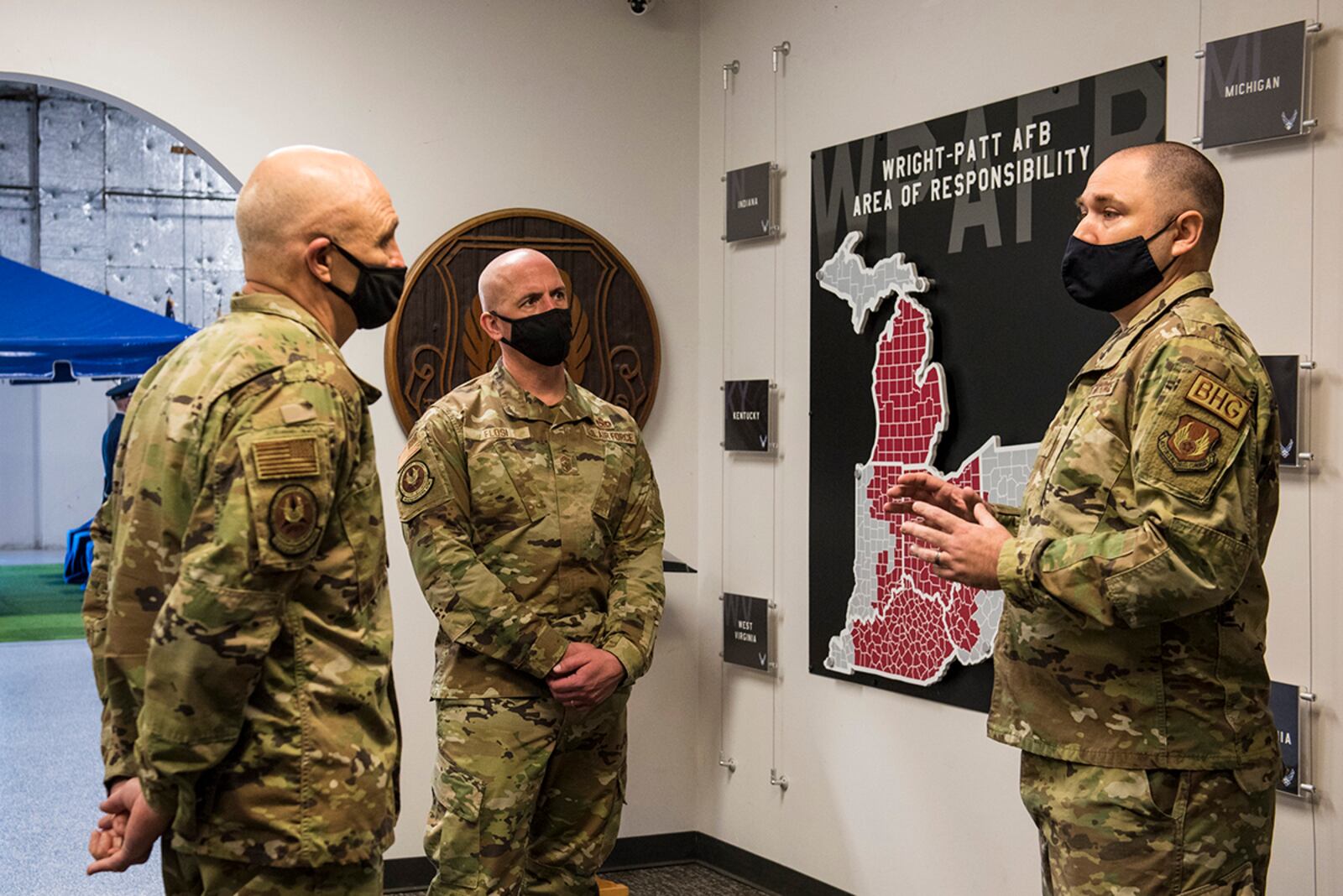 Gen. Arnold W. Bunch, Jr. (left), Air Force Materiel Command commander, and Chief Master Sgt. David Flosi (center), AFMC command chief, discuss the 88th Air Base Wing Honor Guard’s area of responsibility with Master Sgt. Gregory Linker, Honor Guard superintendent, at Wright-Patterson Air Force Base on Jan. 21. U.S. AIR FORCE PHOTO/JAIMA FOGG