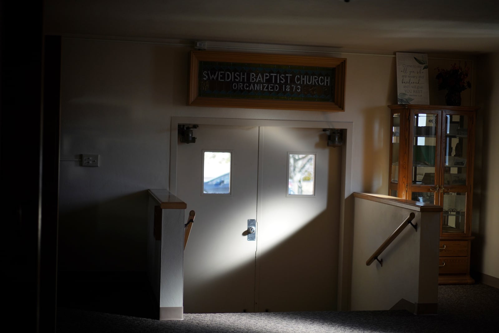 Light shines on the front door of the Indian Lake Baptist Church, formerly The Swedish Baptist Church, in Worthington, Minn., on Sunday, Oct. 20, 2024. (AP Photo/Jessie Wardarski)