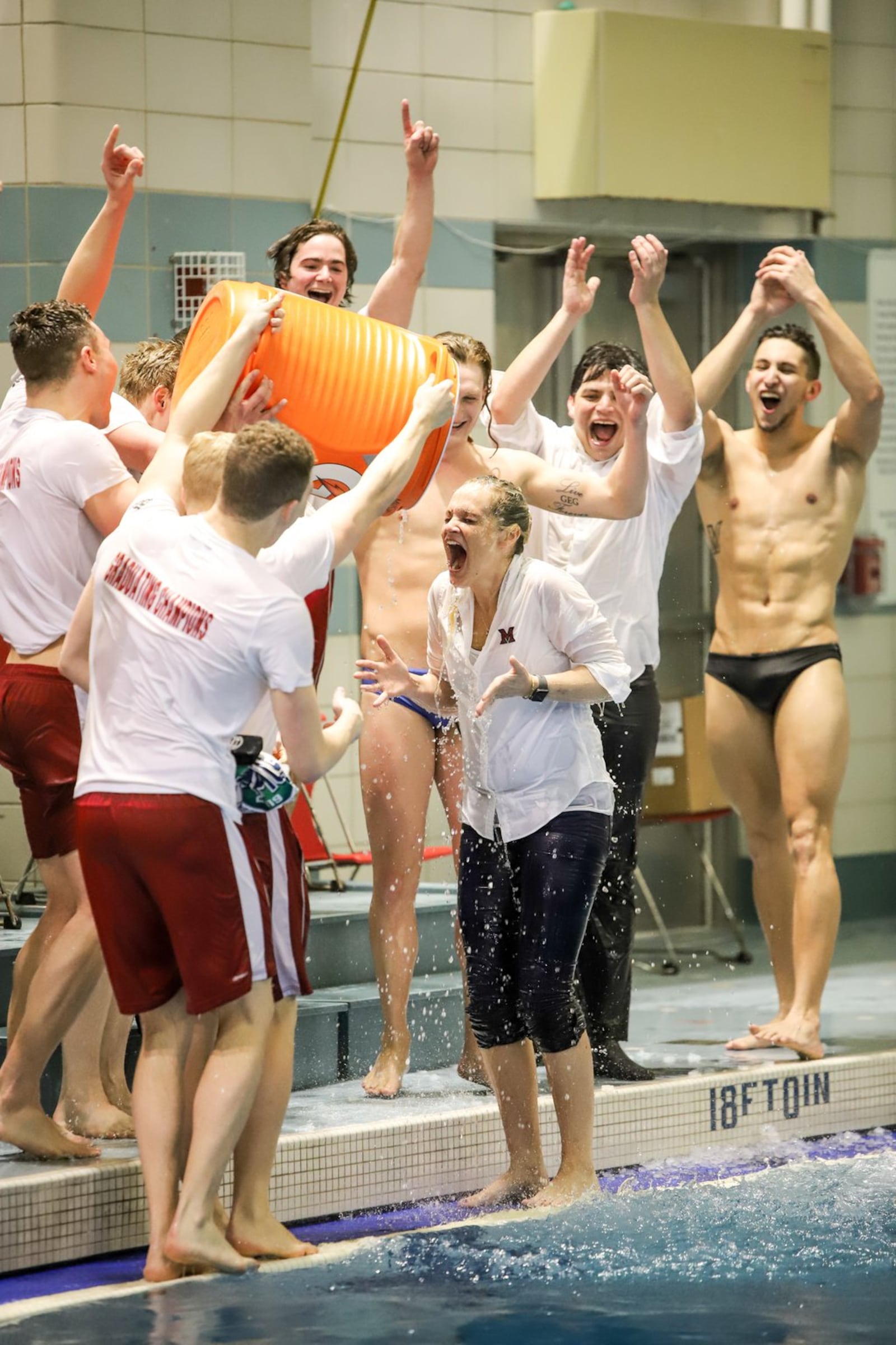 Hollie Bonewit-Cron, the head coach of Miami University s men s and women s swimming and diving teams, became the first female coach in the history of the Mid-American Conference in any sport to lead a men s team to a conference title. Members of the men’s team doused Bonewit-Cron with a water cooler after the team won the MAC title. PHOTO COURTESY OF MIAMI ATHLETICS