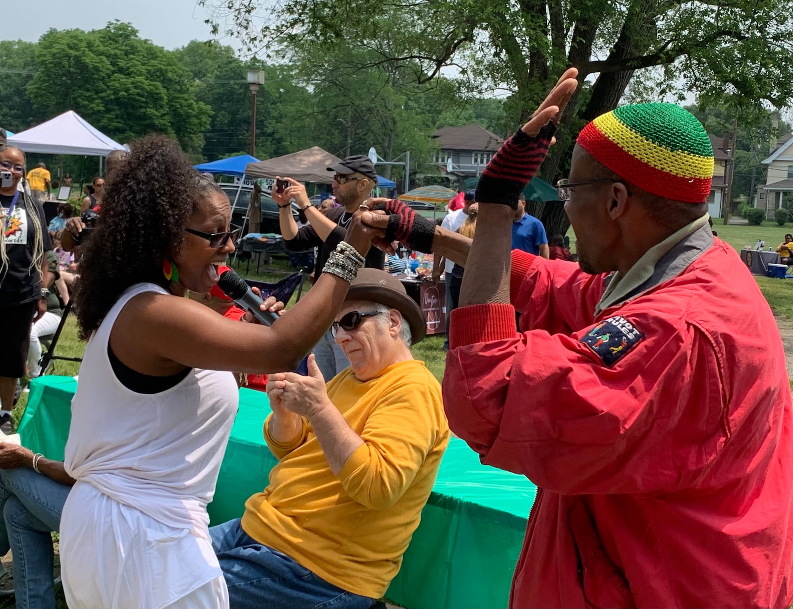 Shamikia Clark of the Chazz Band (left) dances with an audience member during the band’s performance at Dayton’s Juneteenth festival