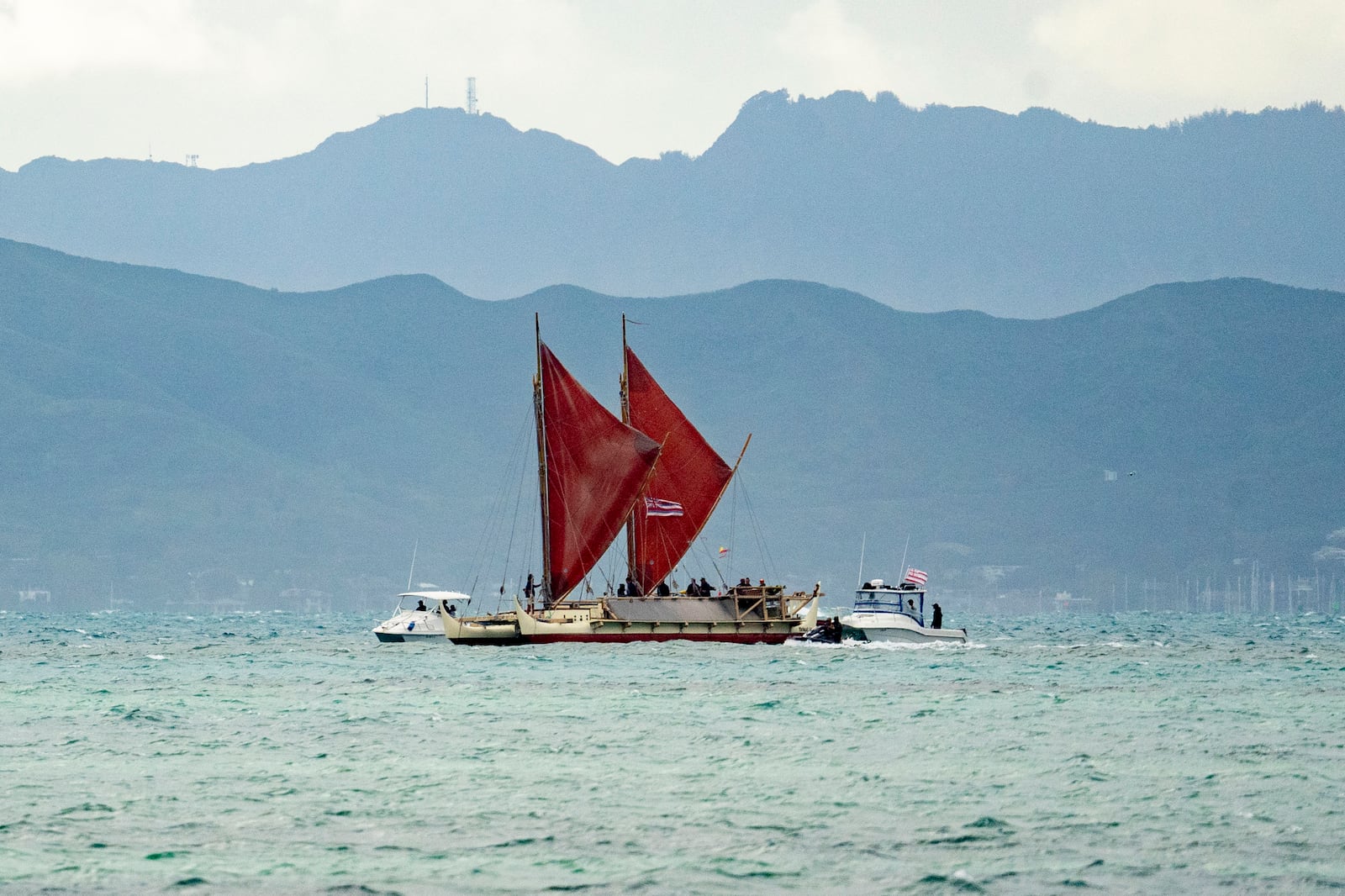 Hokulea sails into the shore of Kualoa Regional Park before its Hokulea's 50th birthday commemoration, Saturday, March 8, 2025, in Kaneohe, Hawaii. (AP Photo/Mengshin Lin)