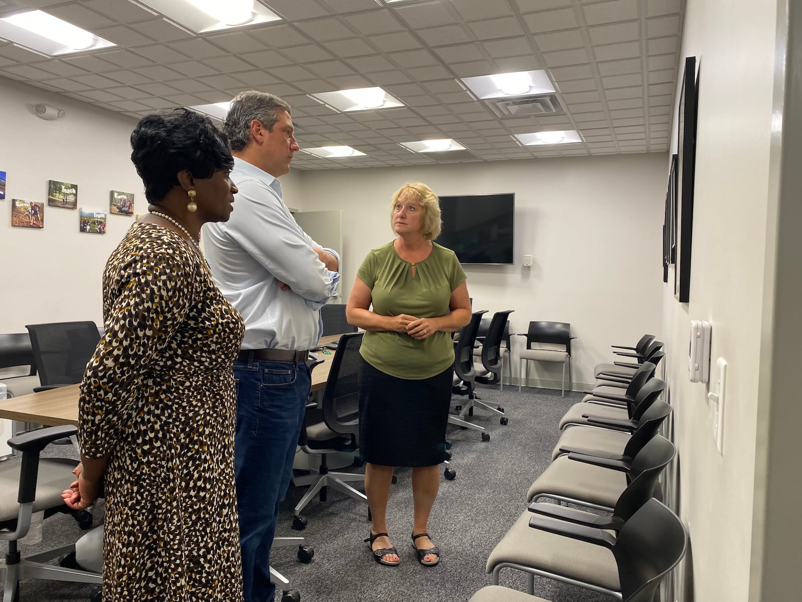 Trotwood mayor Mary McDonald, left, and Congressman Tim Ryan, center, speak with Korrect Plumbing, Heating and Air president Martha Logan at Korrect on Thursday. Eileen McClory / Staff