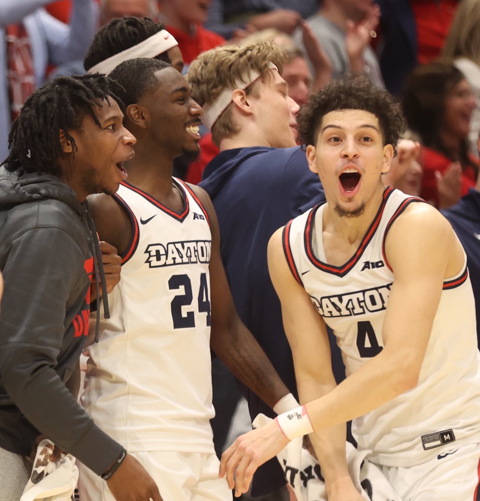 Dayton Flyer basketball players (from left) Malachi Smith, Kobe Elvis, Petras Padegimas and Koby Brea celebrate a 3-point shot by Brady Uhl during UD's victory over Rhode Island on Saturday, Jan. 20, 2024, at UD Arena. David Jablonski/Staff