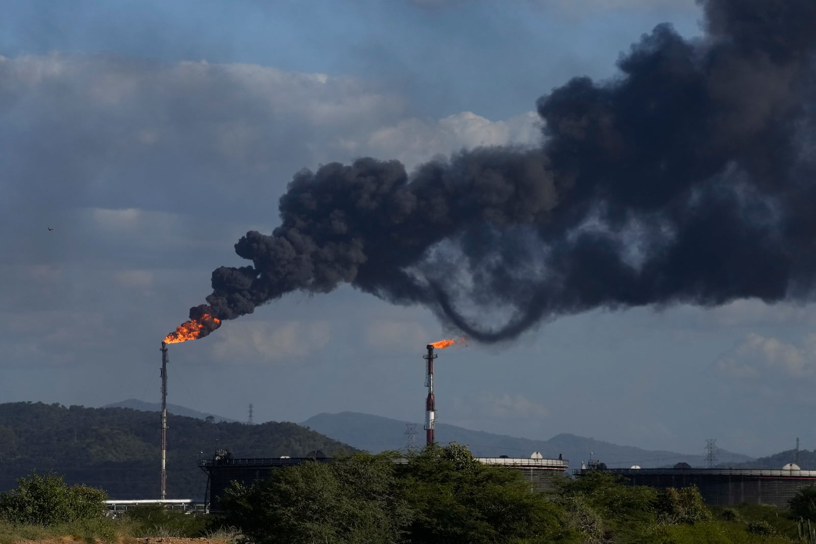 FILE - Flare stacks release gases at the Jose Antonio Anzoategui oil complex in Barcelona, Venezuela, Jan. 9, 2024. (AP Photo/Matias Delacroix, File)