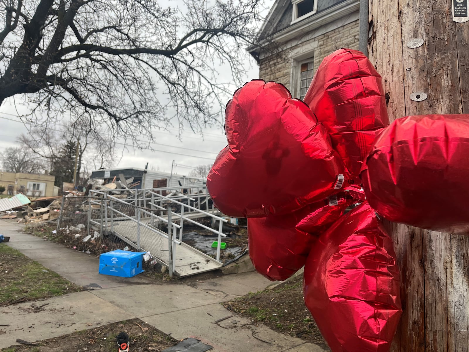 Five heart-shaped balloons were hung on a utility pole near the site of a fire on North Broadway Street in Dayton where authorities recovered the bodies of five people. Photo taken on March 10, 2023. CORNELIUS FROLIK / STAFF