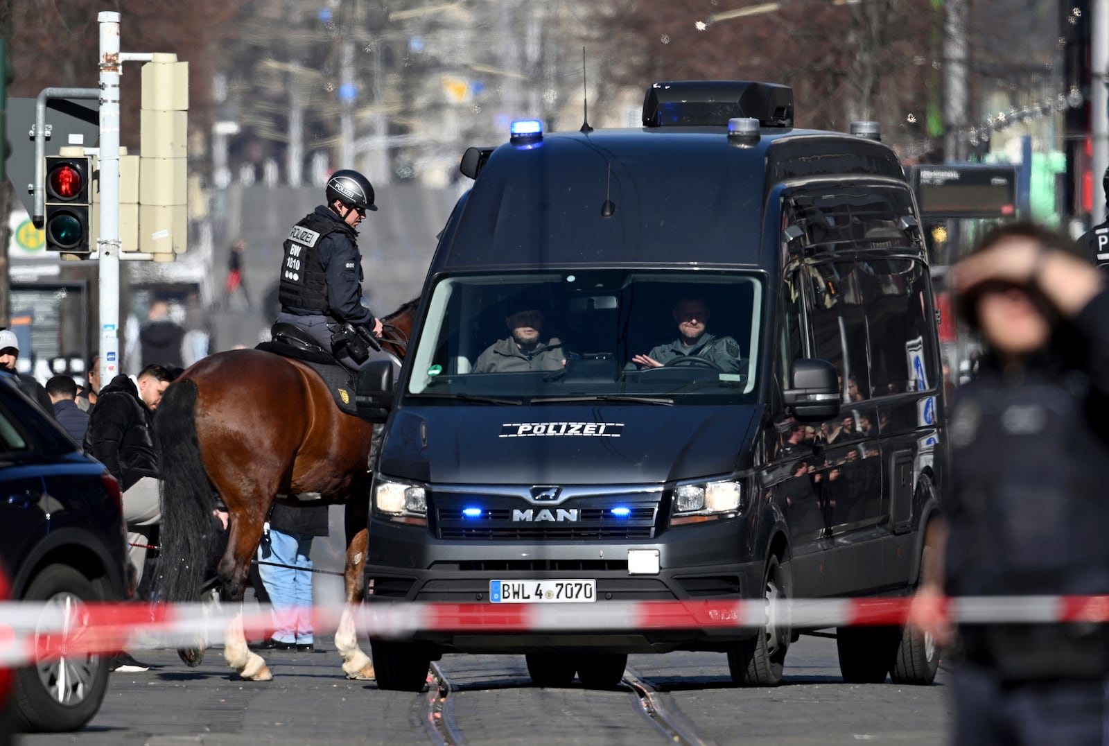 Police officers secure a street in the city center of Mannheim, Germany, Monday March 3, 2025, following an incident in which one person was killed and others injured when a car rammed into a crowd, German police said. (Boris Roessler/dpa via AP)