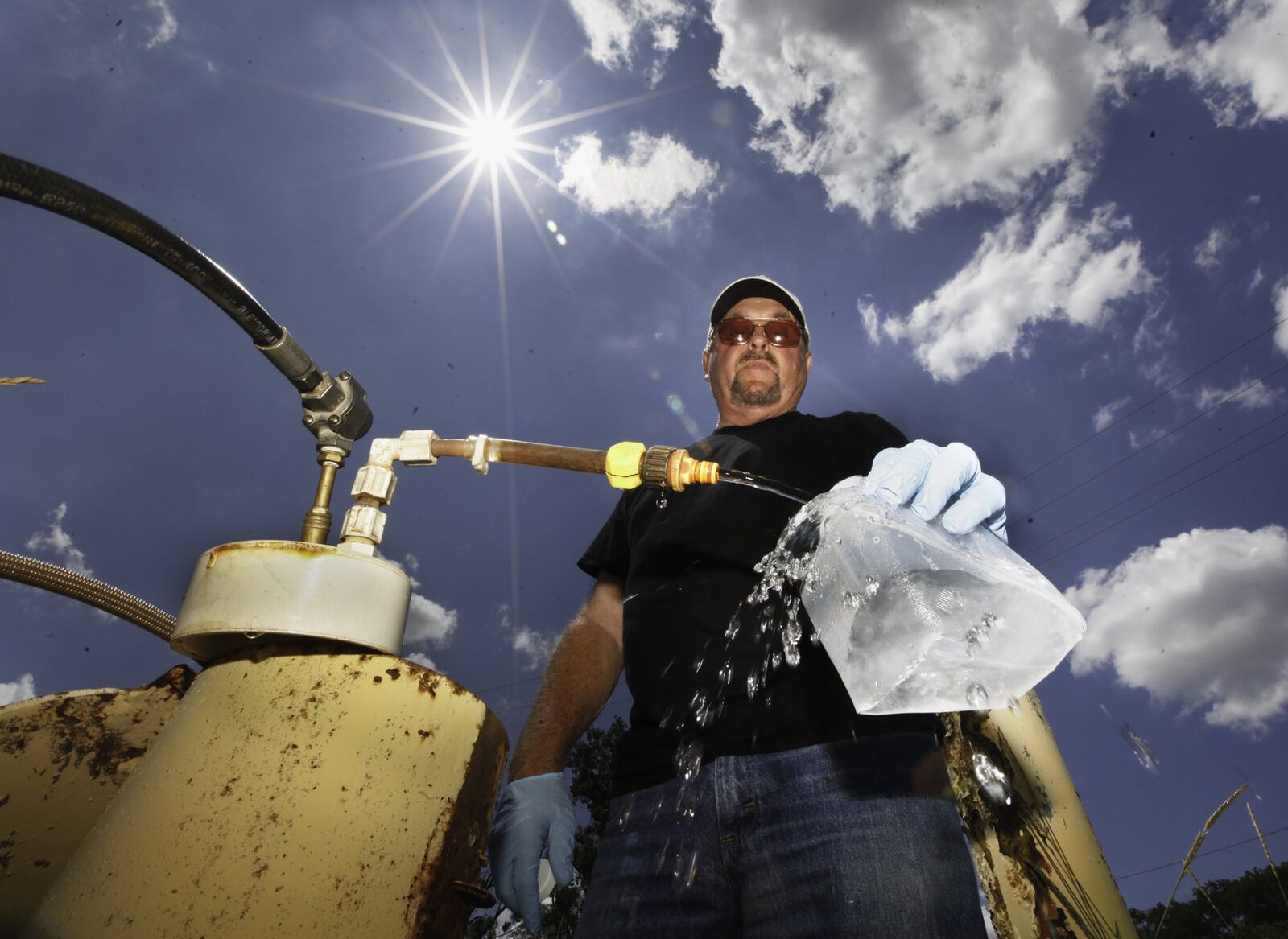 Dan Day, a water lab technician with the City of Dayton, takes a sample from one of 200 monitoring wells used to check on the quality of water in the Great Miami Buried Valley Aquifer and test for any contaminants on a regular basis. CHRIS STEWART / STAFF