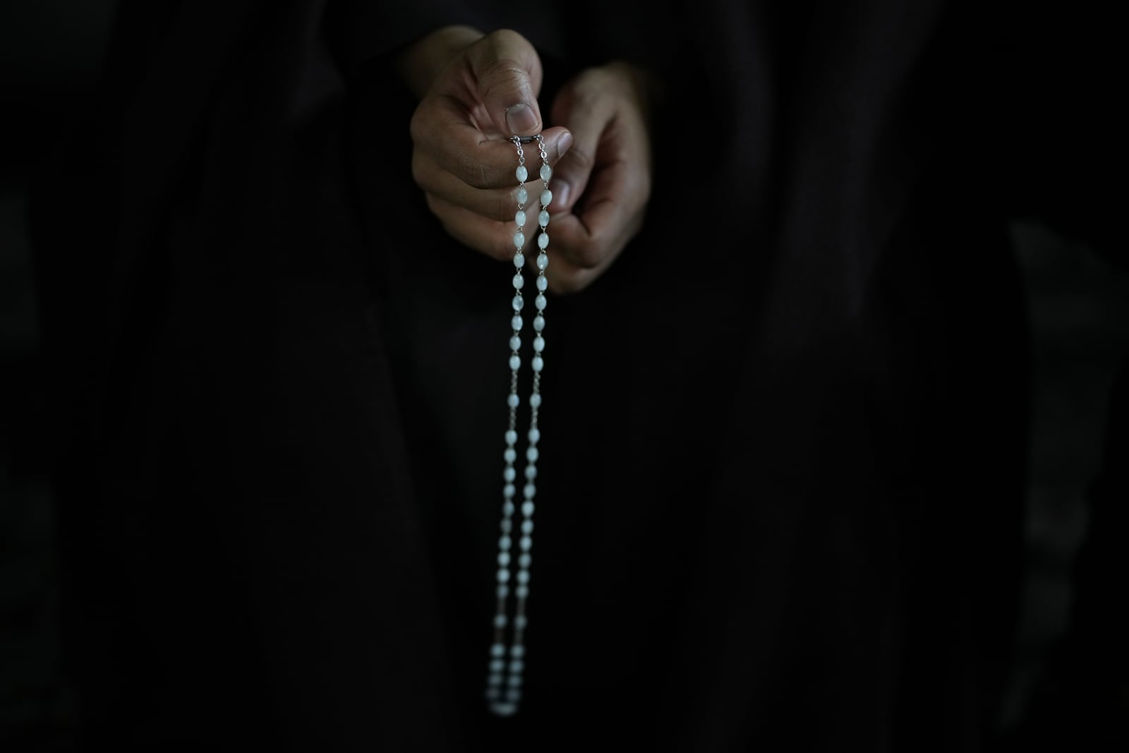 A man holds a rosary beads during a rosary prayer for Pope Francis' health in St. Peter's Square at the Vatican, Tuesday, March 4, 2025. (AP Photo/Alessandra Tarantino)