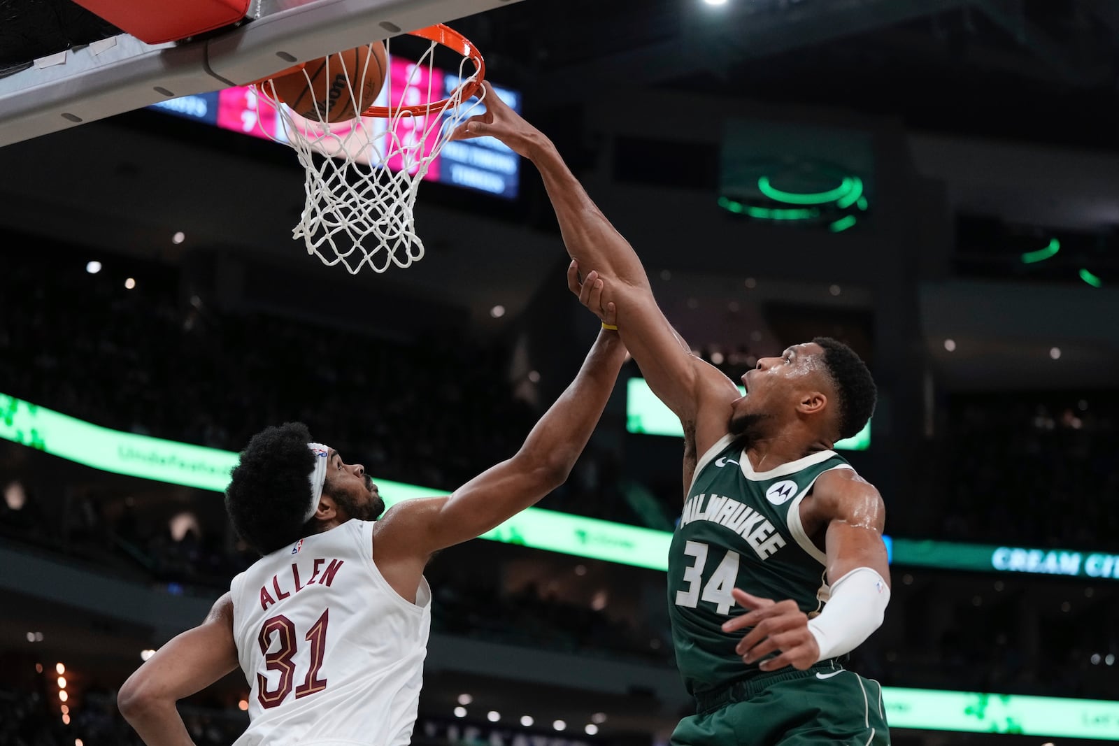 Milwaukee Bucks' Giannis Antetokounmpo dunks over Cleveland Cavaliers' Jarrett Allen during the first half of an NBA basketball game Saturday, Nov. 2, 2024, in Milwaukee. (AP Photo/Morry Gash)