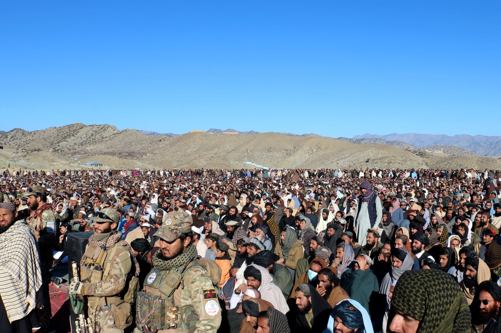 People attend the funeral prayer of Khalil Haqqani, the minister for refugees and repatriation, during his funeral procession in eastern Paktia province, Afghanistan, Thursday, Dec. 12, 2024. (AP Photo/Saifullah Zahir)