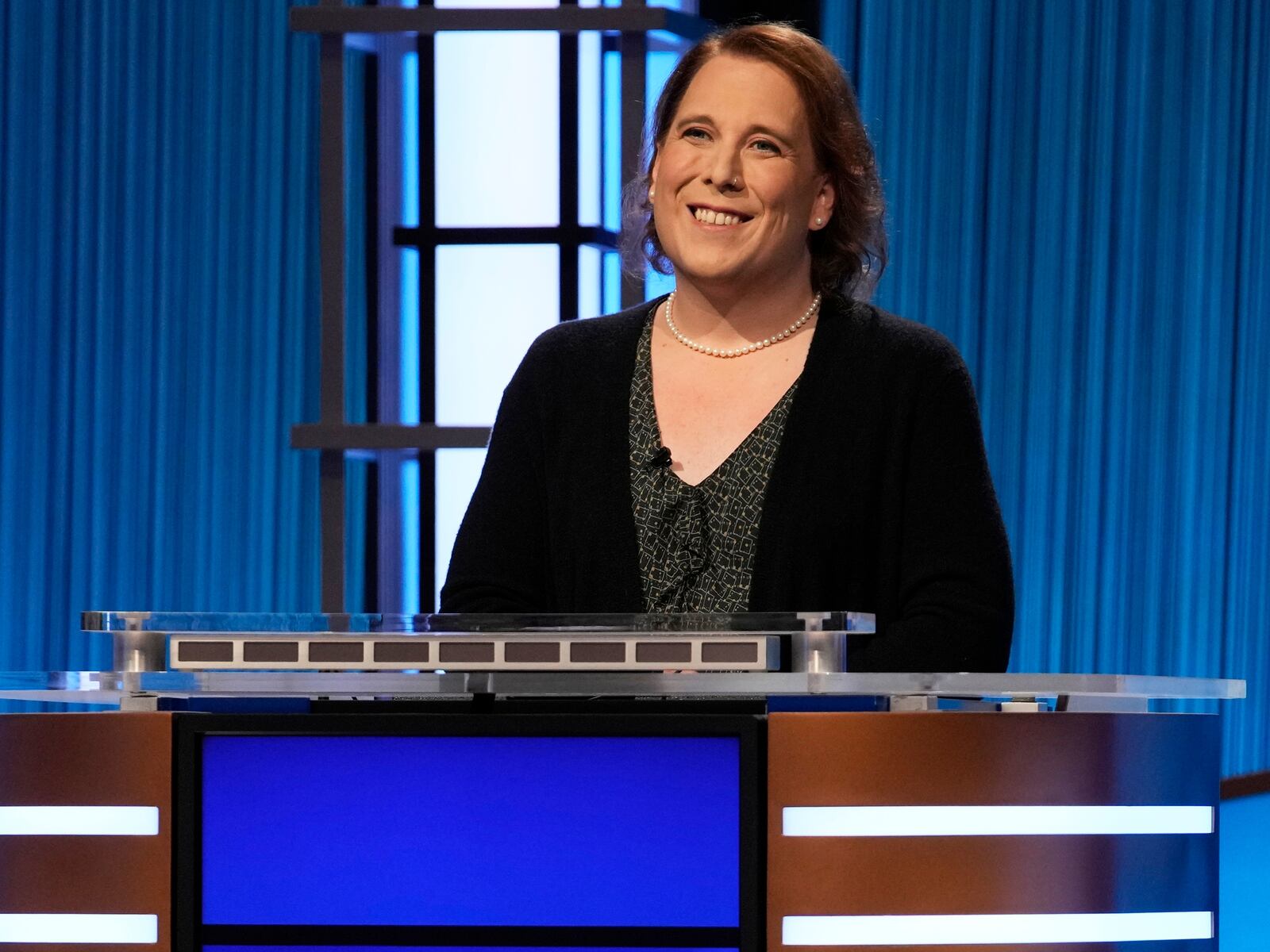 This image provided by Jeopardy Productions, Inc. shows game show champion Amy Schneider on the set of "Jeopardy!" Schneider is the first trans person to qualify for the show's Tournament of Champions. (Jeopardy Productions, Inc. via AP)