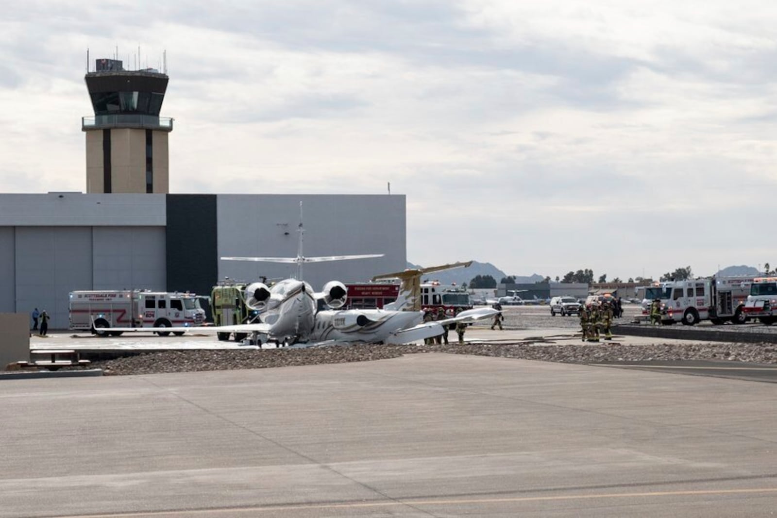 This photo provided by Instagram account @donniefitz2 shows fire crews at the Scottsdale Airport in Scottsdale, Arizona, following the collision of two jets on Monday, Feb. 10, 2025. (@donniefitz2 via AP)