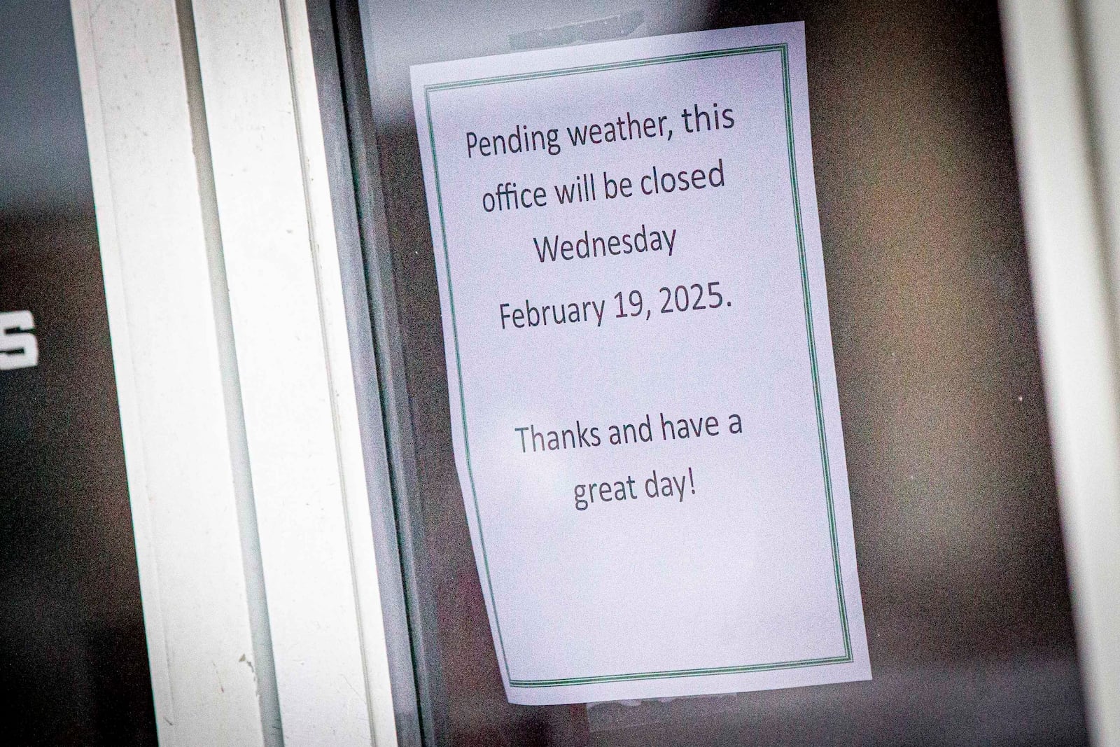 A store in downtown provides signage about potential winter weather impacting their hours in Florence, Ala., Wednesday, Feb. 19, 2025. (Dan Busey/The TimesDaily via AP)