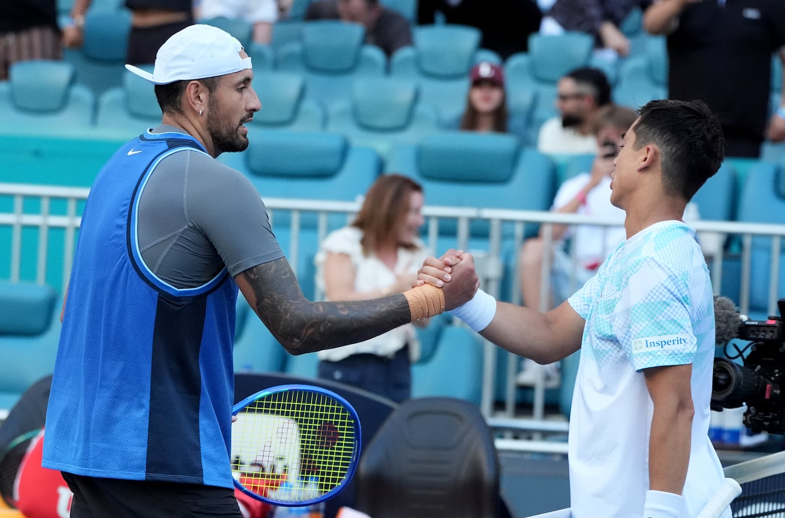 Nick Kyrgios, of Australia, left, shakes hands with Mackenzie McDonald, right, after winning their match during the Miami Open tennis tournament, Wednesday, March 19, 2025, in Miami Gardens, Fla. (AP Photo/Lynne Sladky)