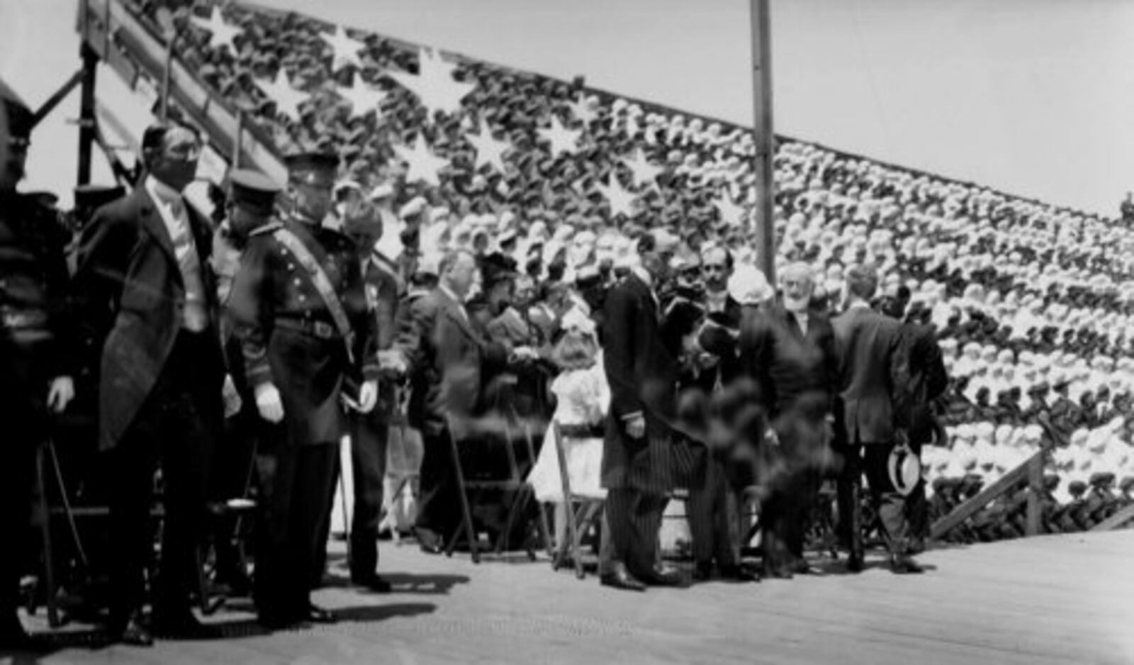 A double exposed image of Wilbur, Orville, and Bishop Milton Wright who are on stage for the medals ceremony during the 1909 Wright Brothers Homecoming Celebration -- 1909 at the Montgomery County Fairgrounds.