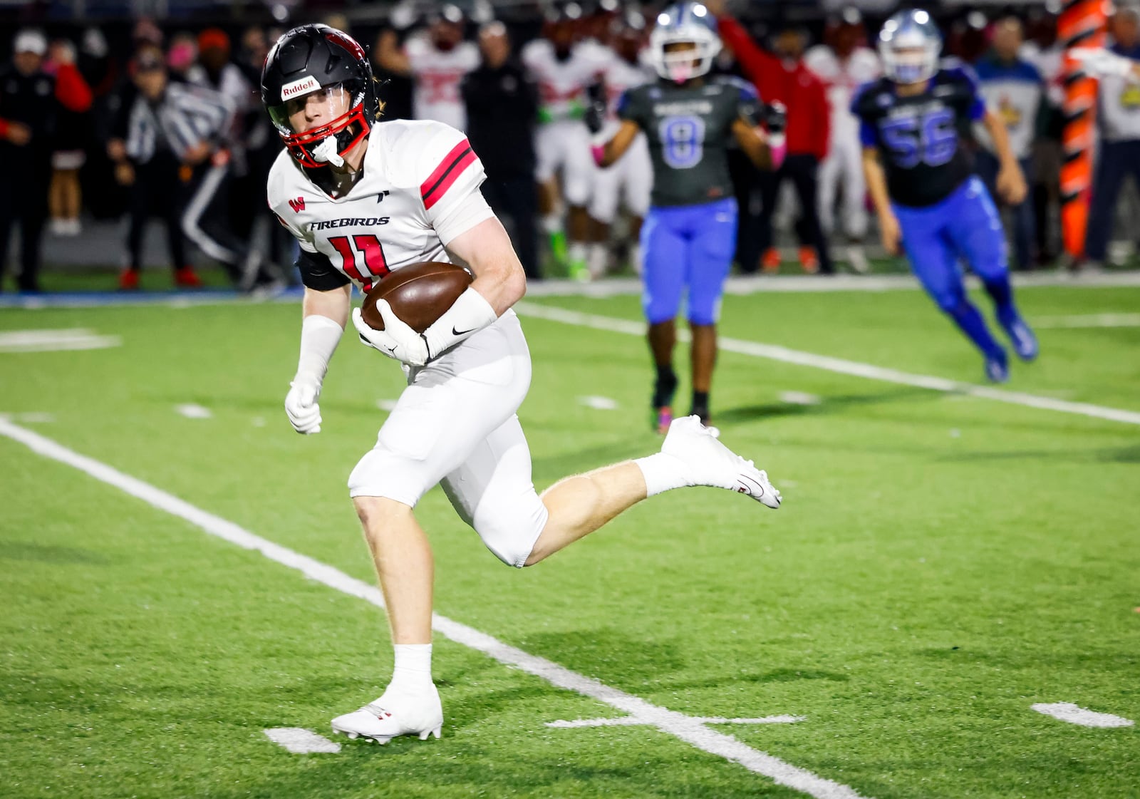 Lakota West's Jason Asbeck runs back an interception for a touchdown during their football game against Hamilton Friday, Oct. 20, 2023 at Virgil M. Schwarm Stadium in Hamilton. Lakota West won 42-14. NICK GRAHAM/STAFF