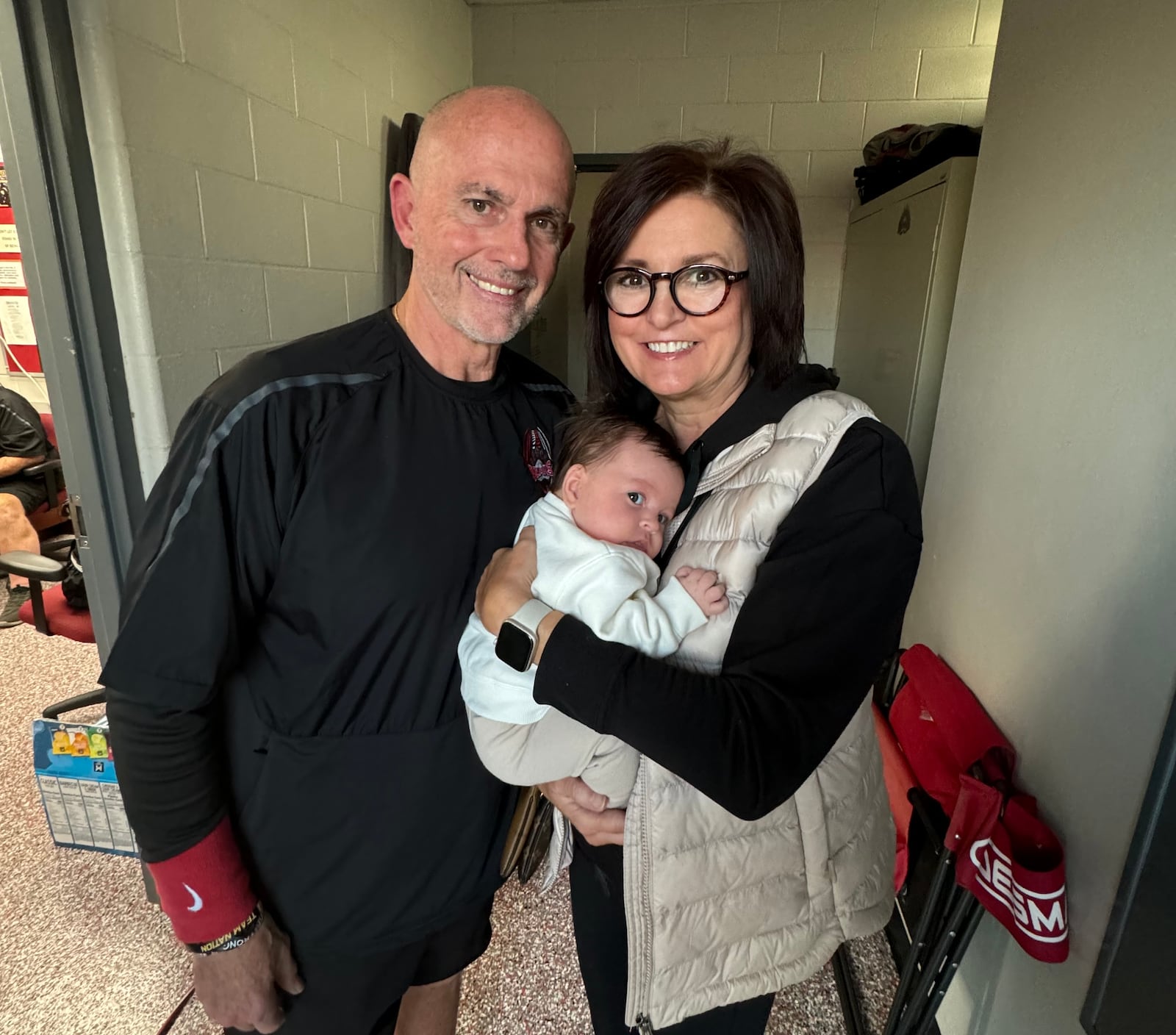 Northridge football coach Bob Smith and his wife Debra with their granddaughter, Quinn. CONTRIBUTED