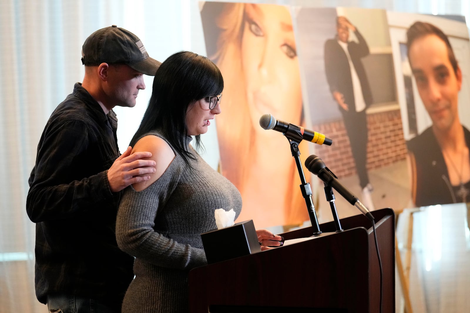 Ashtin Gamblin, survivor of the Club Q nightclub mass shooting in Colorado Springs, Colo., is consoled by her husband Robert Conner Jr., during a news conference announcing the filing of a civil complaint on the two-year anniversary of the deadly mass shooting, Tuesday, Nov. 19, 2024, in Denver. (AP Photo/Jack Dempsey)